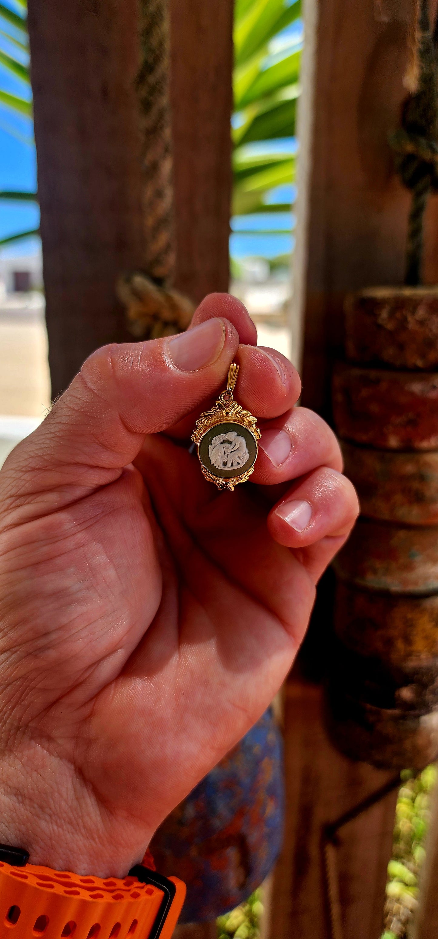 This beautiful vintage 1980s pendant features an authentic Wedgwood jasperware panel, set within an ornate yellow gold-plated frame that gives it a rich, regal presence.