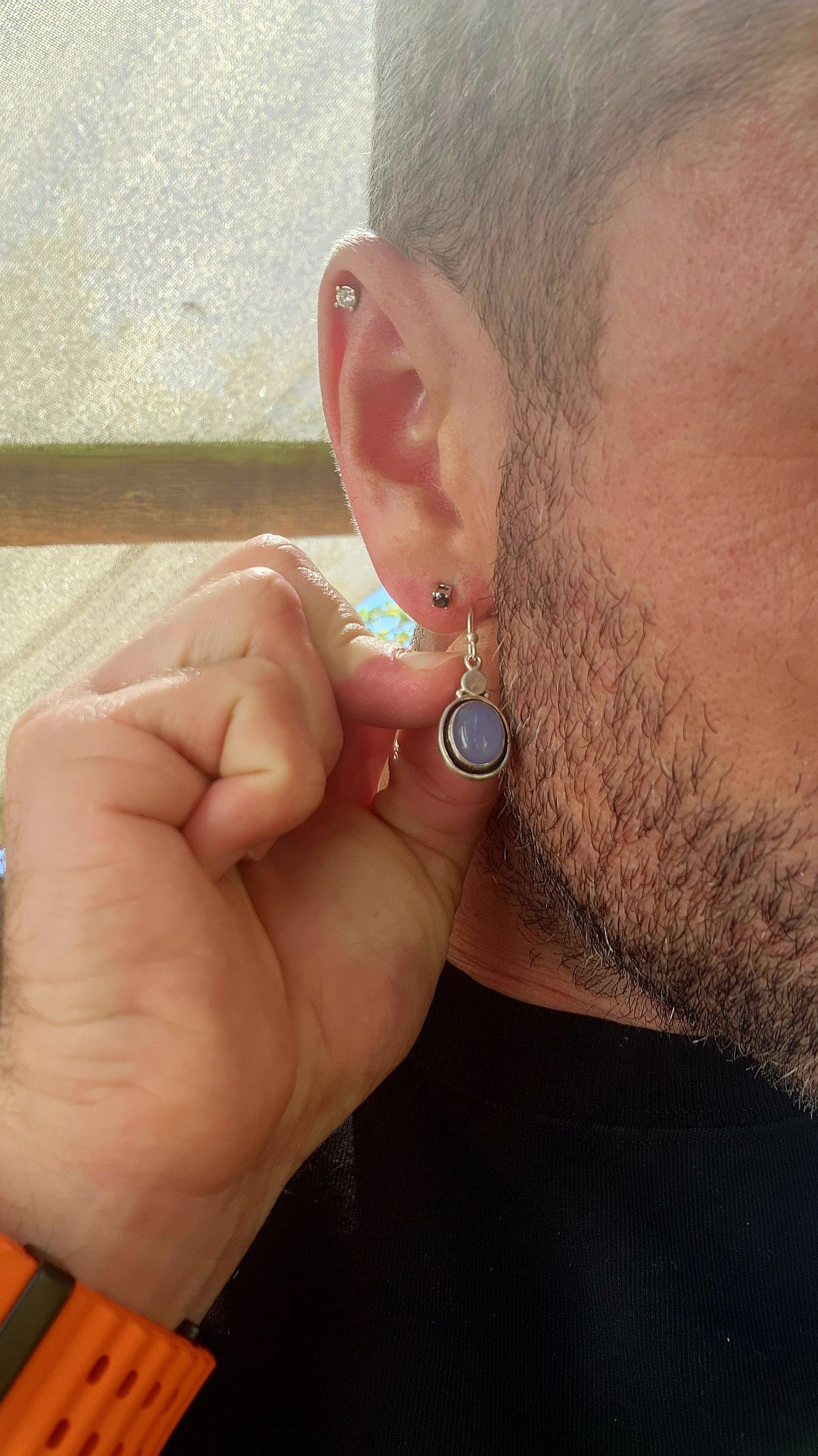 This artisan-made pair of sterling silver drop earrings features smooth, oval lavender-blue chalcedony cabochons, each beautifully tube-set in polished silver.