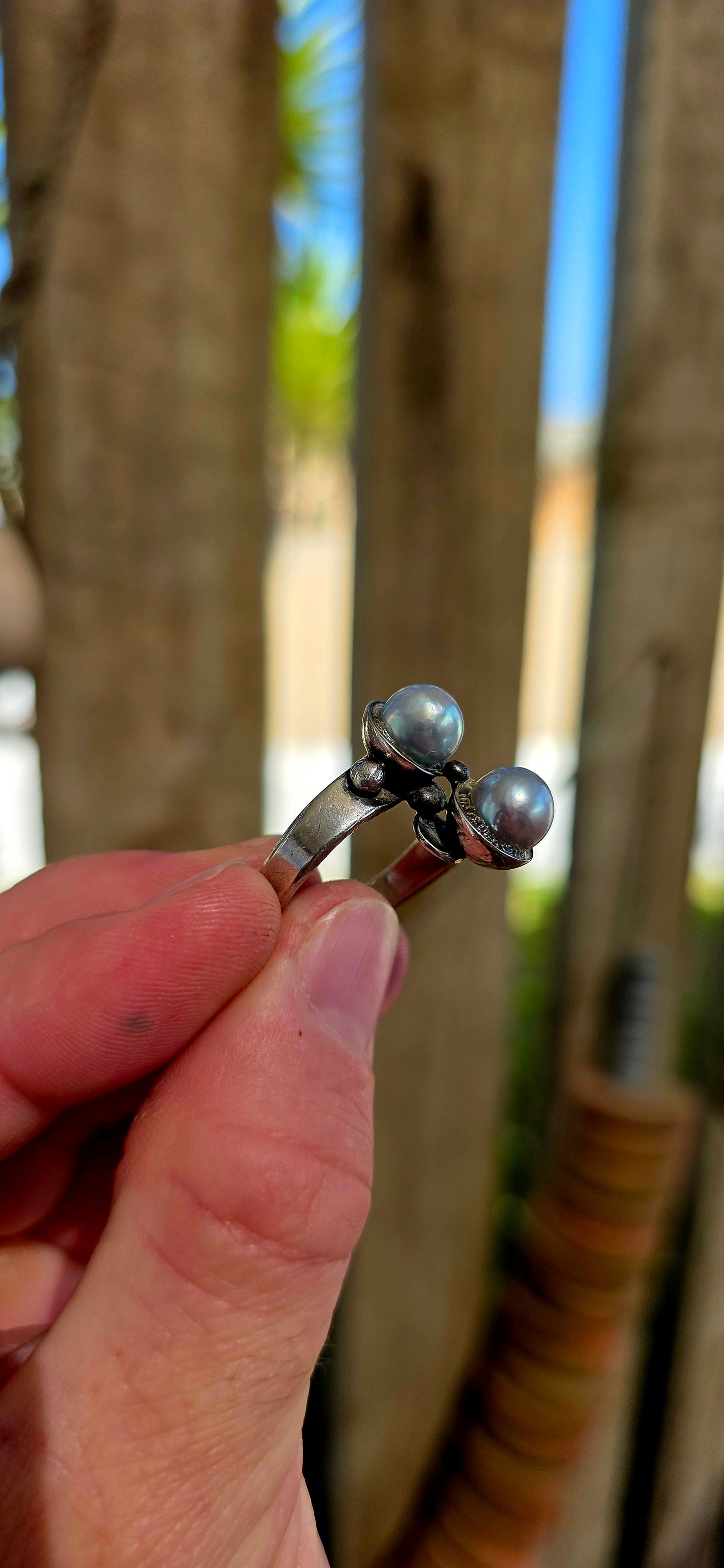 This striking circa 1970’s modernist artisan-made set consists of a sculptural Toi et Moi cross-over ring and matching clip-on earrings, all crafted in sterling silver and signed by the artist.