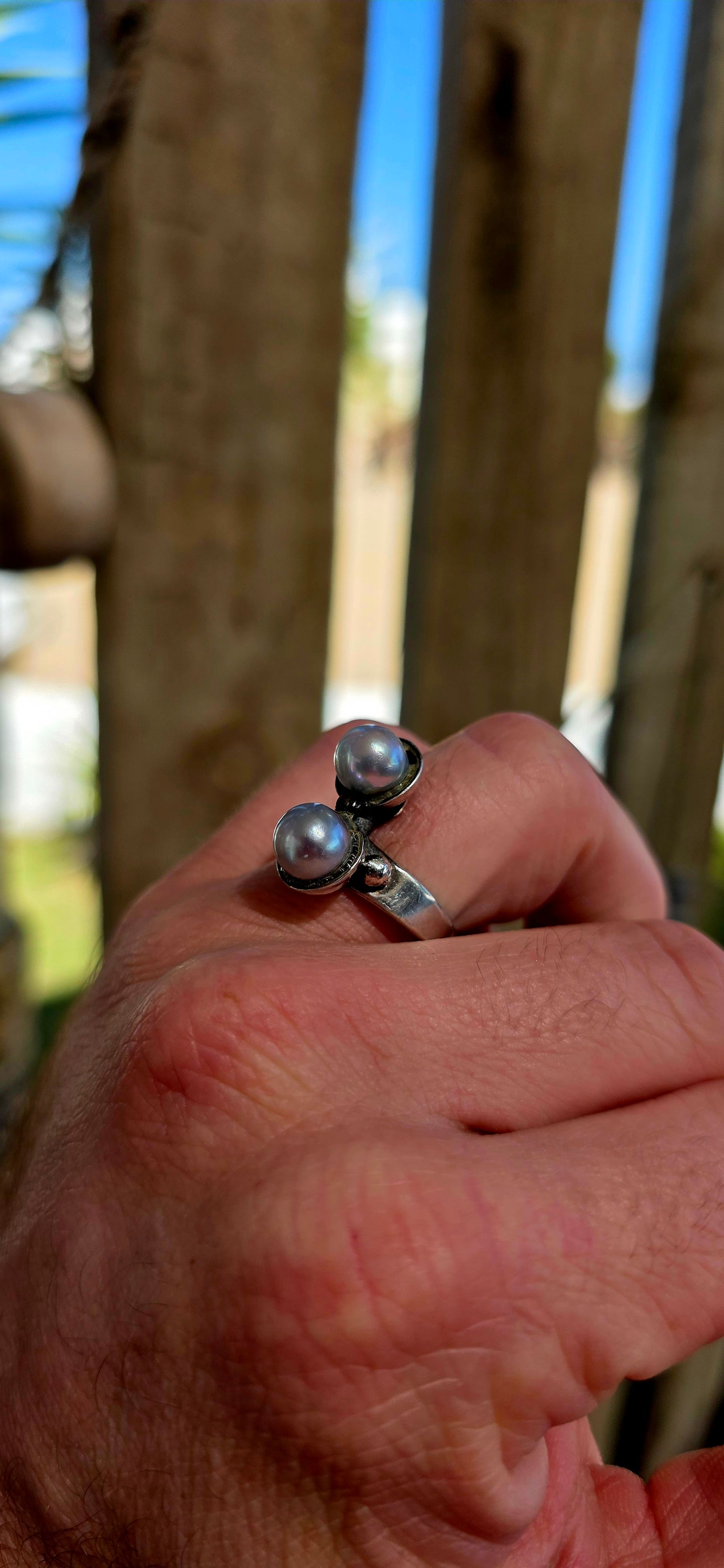 This striking circa 1970’s modernist artisan-made set consists of a sculptural Toi et Moi cross-over ring and matching clip-on earrings, all crafted in sterling silver and signed by the artist.