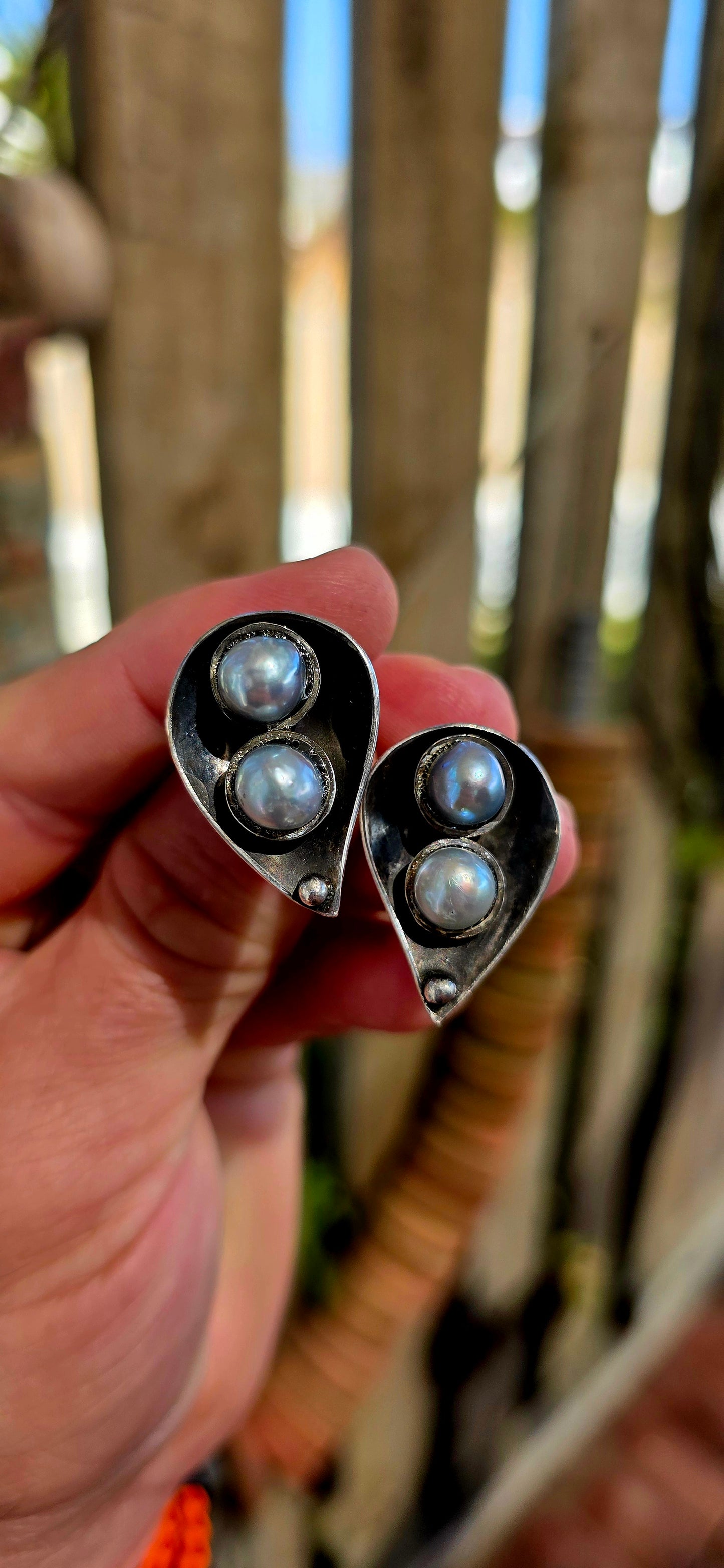 This striking circa 1970’s modernist artisan-made set consists of a sculptural Toi et Moi cross-over ring and matching clip-on earrings, all crafted in sterling silver and signed by the artist.