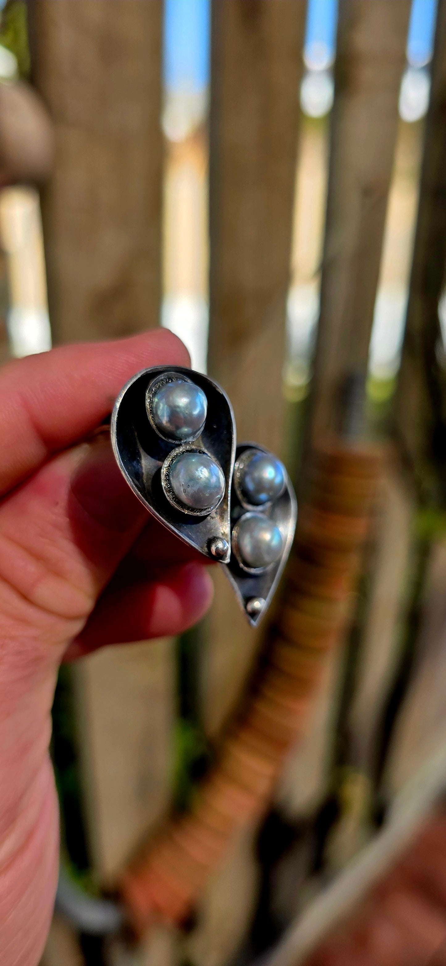 This striking circa 1970’s modernist artisan-made set consists of a sculptural Toi et Moi cross-over ring and matching clip-on earrings, all crafted in sterling silver and signed by the artist.