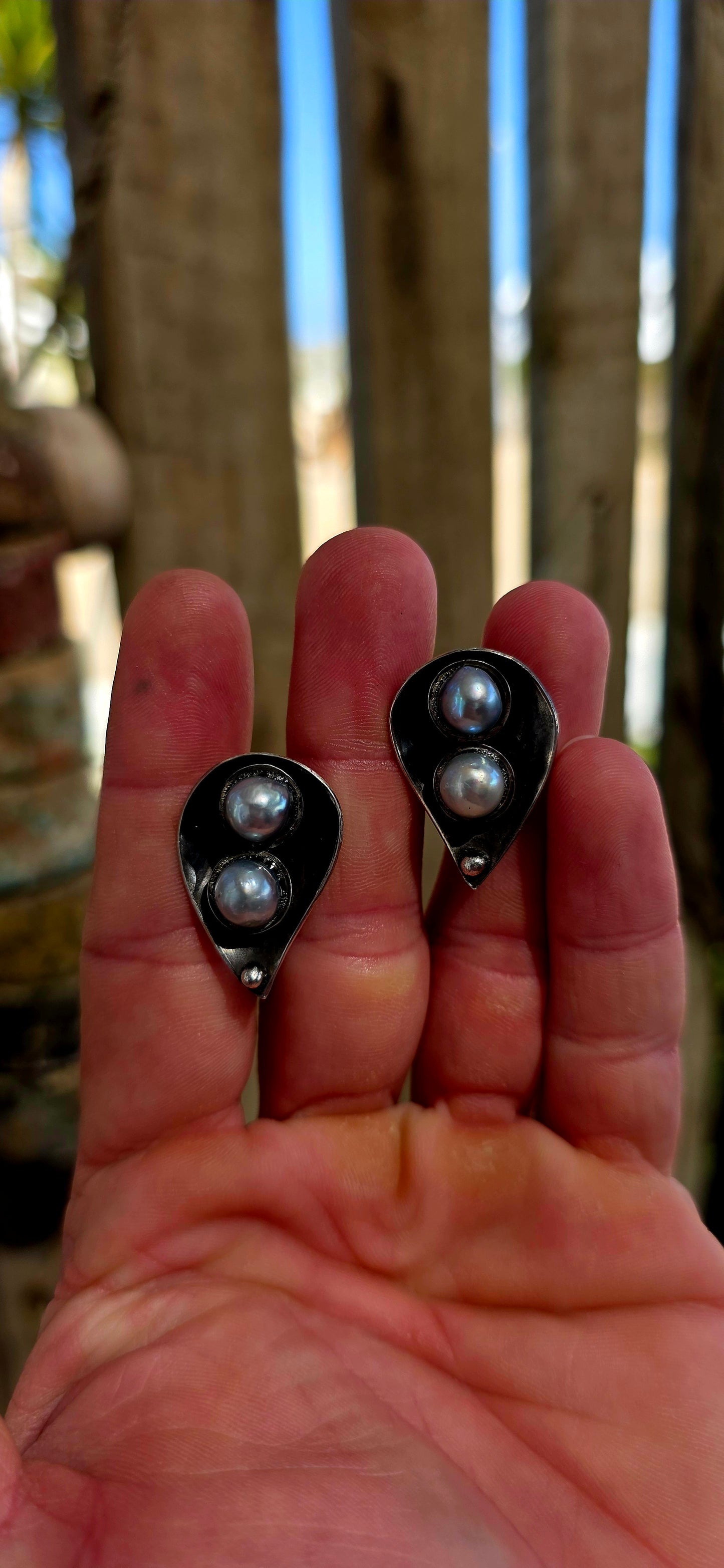 This striking circa 1970’s modernist artisan-made set consists of a sculptural Toi et Moi cross-over ring and matching clip-on earrings, all crafted in sterling silver and signed by the artist.