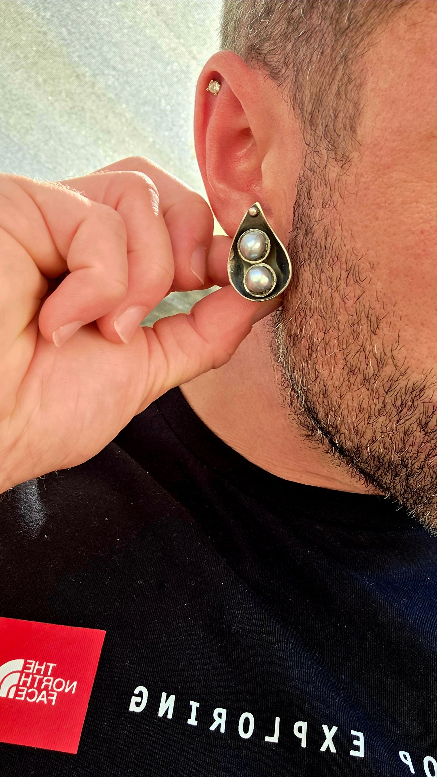 This striking circa 1970’s modernist artisan-made set consists of a sculptural Toi et Moi cross-over ring and matching clip-on earrings, all crafted in sterling silver and signed by the artist.