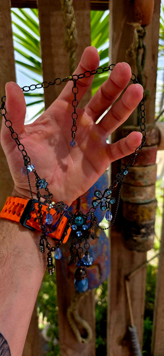 This fabulous designer costume necklace is crafted in an antique bronze-tone metal, giving it a warm, slightly vintage patina — the perfect backdrop for all those luminous blue rhinestones.