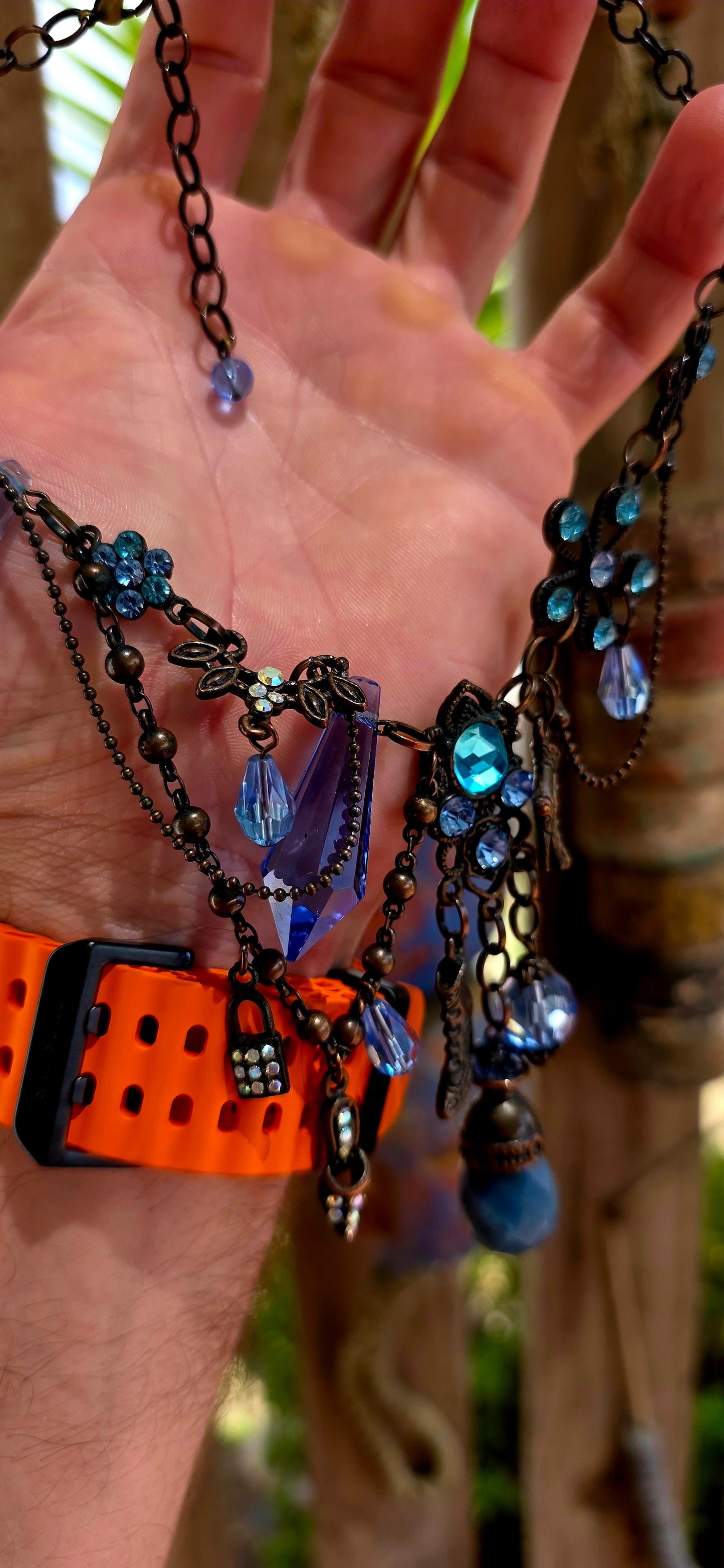 This fabulous designer costume necklace is crafted in an antique bronze-tone metal, giving it a warm, slightly vintage patina — the perfect backdrop for all those luminous blue rhinestones.
