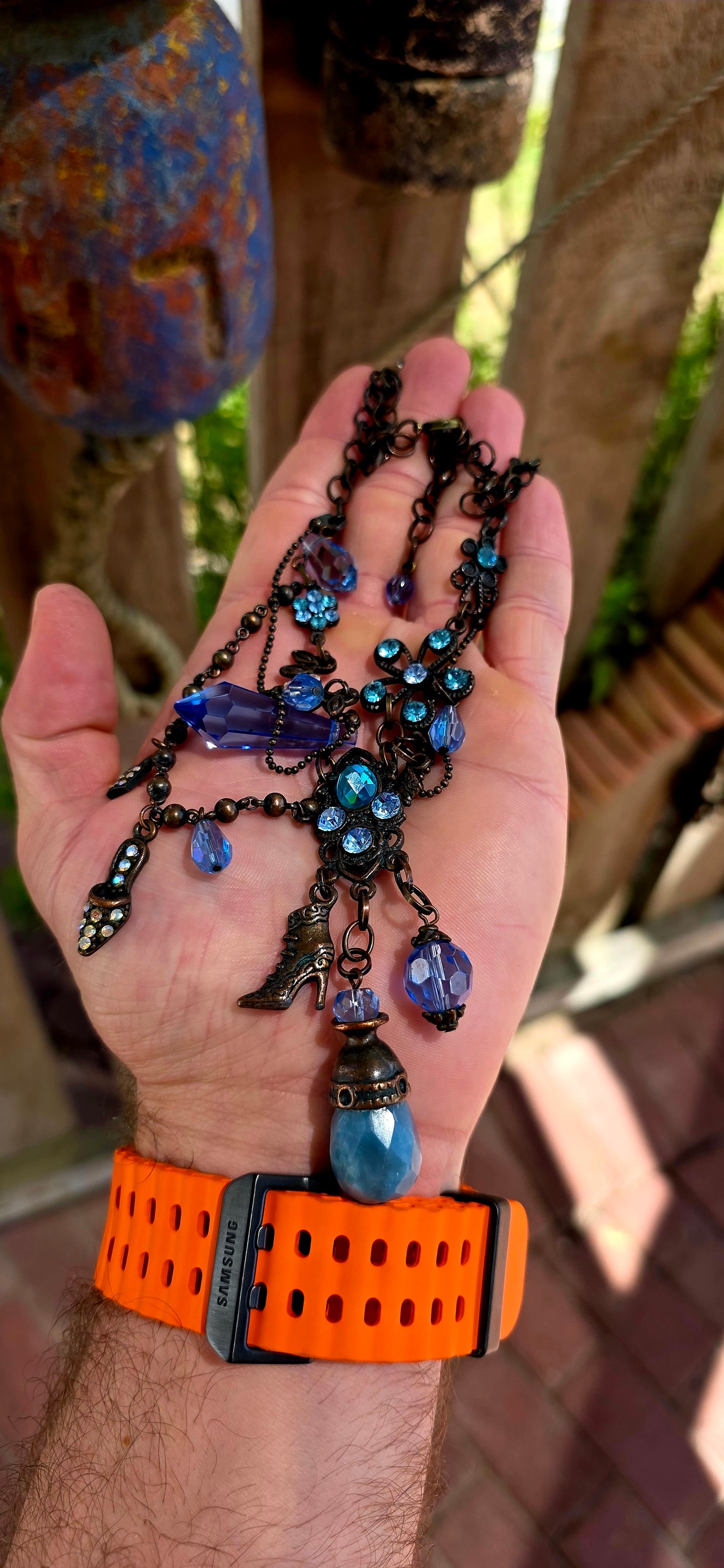 This fabulous designer costume necklace is crafted in an antique bronze-tone metal, giving it a warm, slightly vintage patina — the perfect backdrop for all those luminous blue rhinestones.
