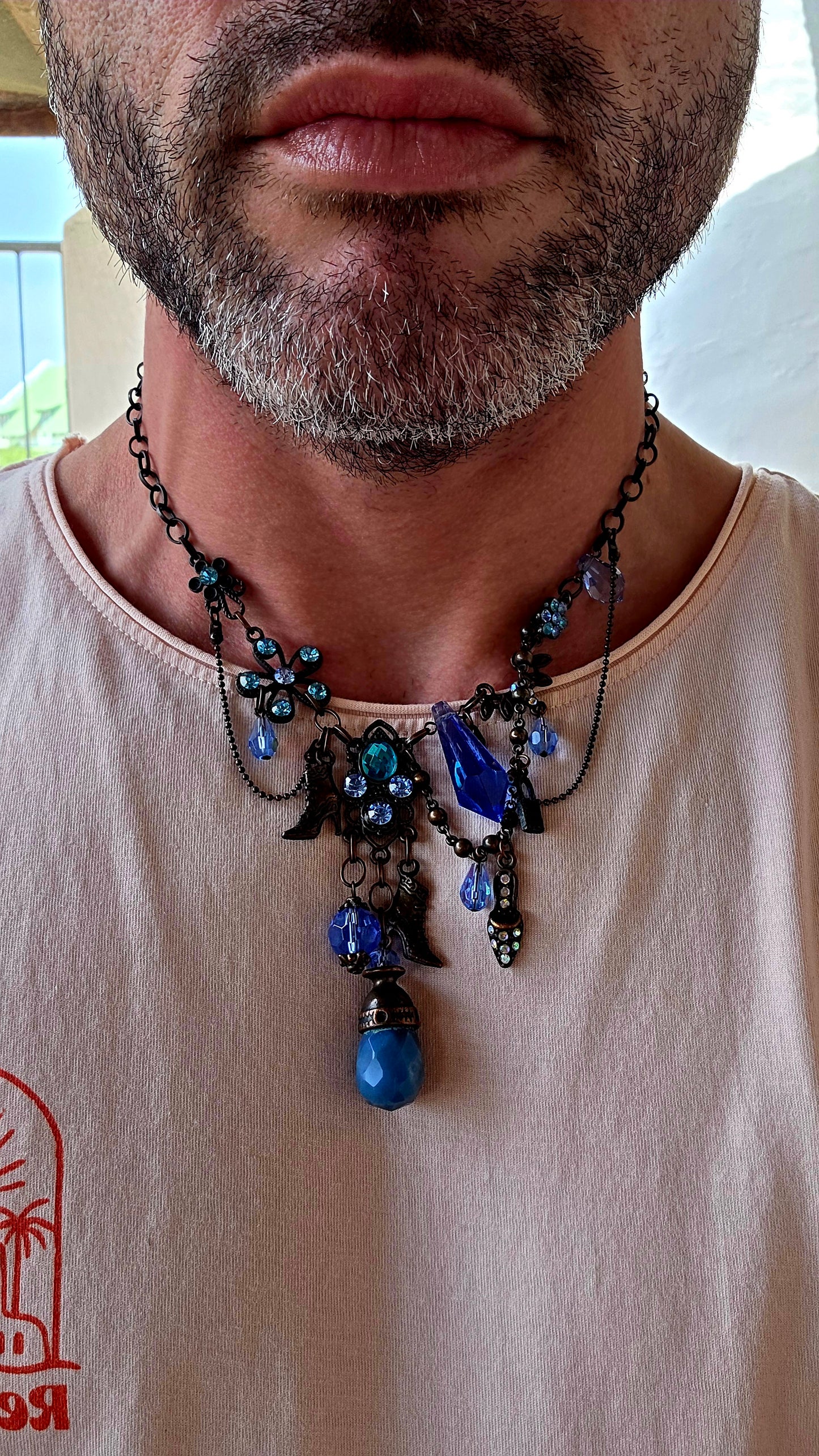 This fabulous designer costume necklace is crafted in an antique bronze-tone metal, giving it a warm, slightly vintage patina — the perfect backdrop for all those luminous blue rhinestones.