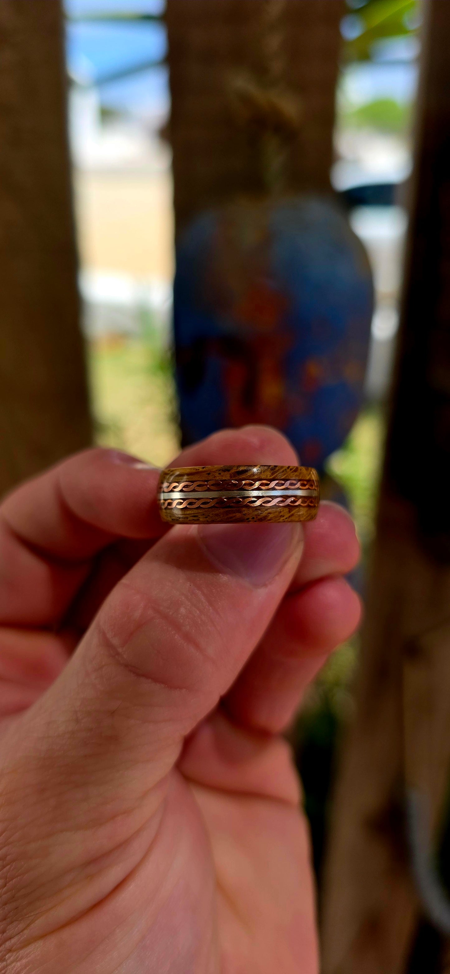 This beautifully crafted artisan ring features a solid sterling silver inner band for strength and structure, wrapped in a rich natural wood exterior that brings warmth and raw organic character.