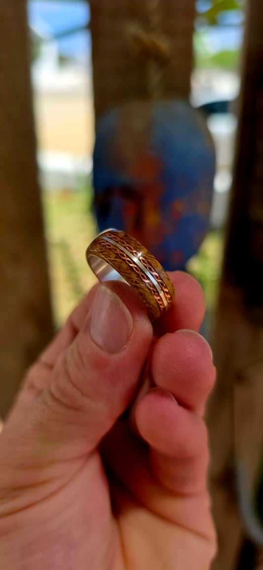 This beautifully crafted artisan ring features a solid sterling silver inner band for strength and structure, wrapped in a rich natural wood exterior that brings warmth and raw organic character.