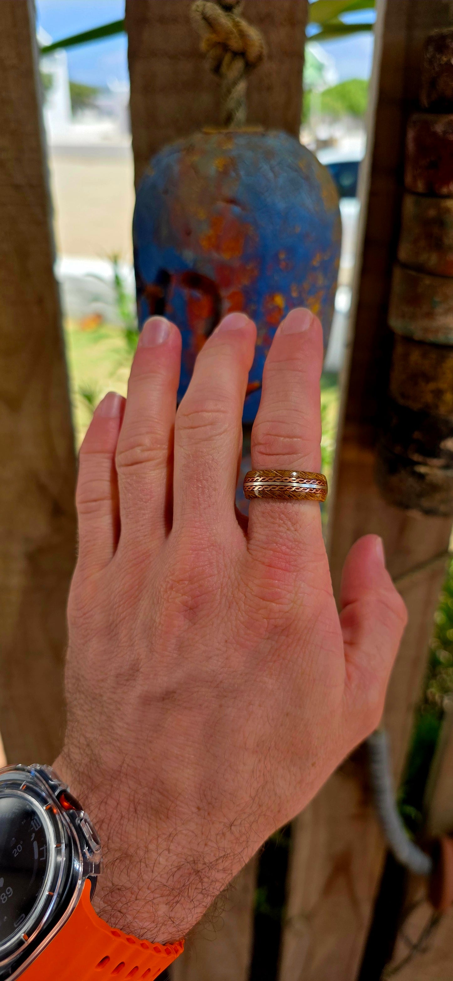 This beautifully crafted artisan ring features a solid sterling silver inner band for strength and structure, wrapped in a rich natural wood exterior that brings warmth and raw organic character.