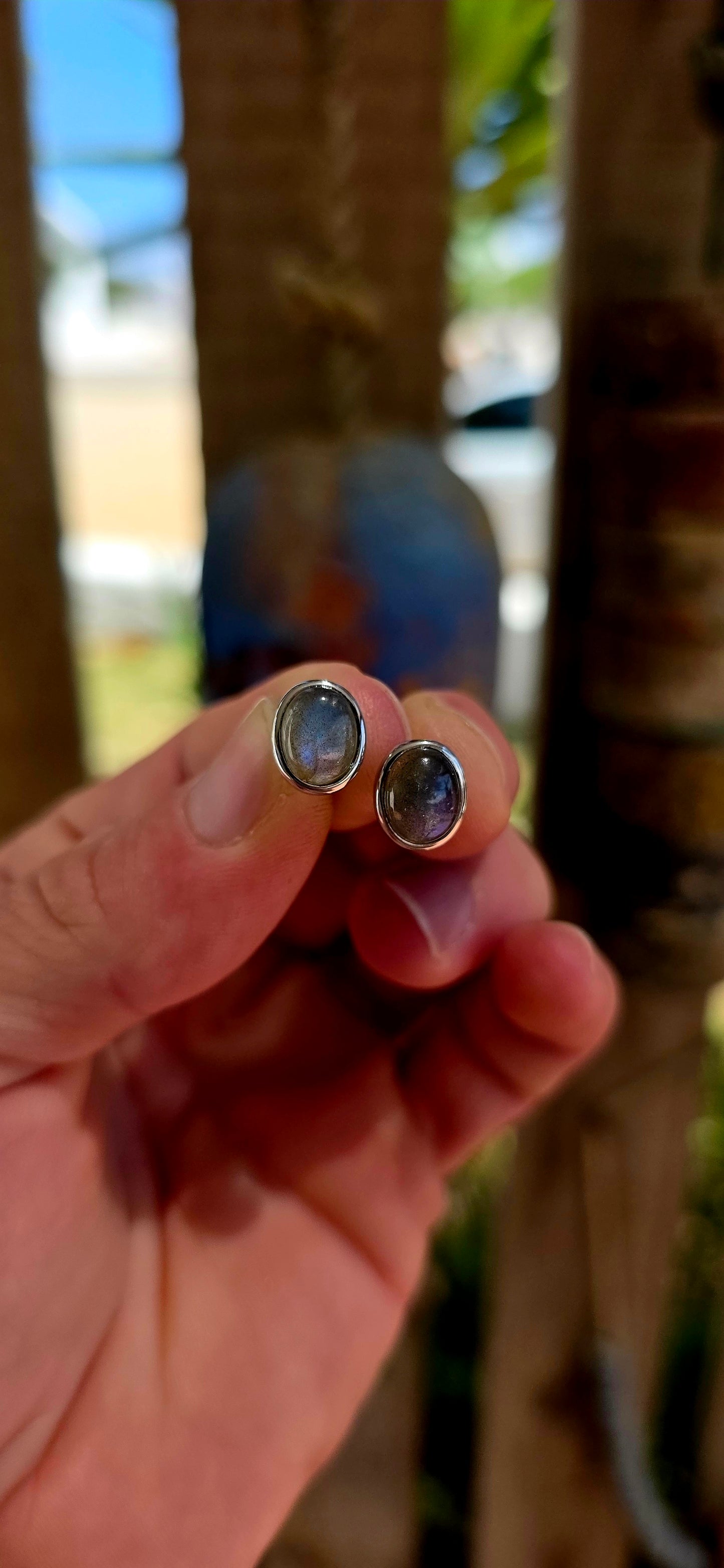 This beautiful unisex pair of sterling silver stud earrings features glowing oval-cut labradorite cabochons, securely tube-set in sleek sterling silver bezels.