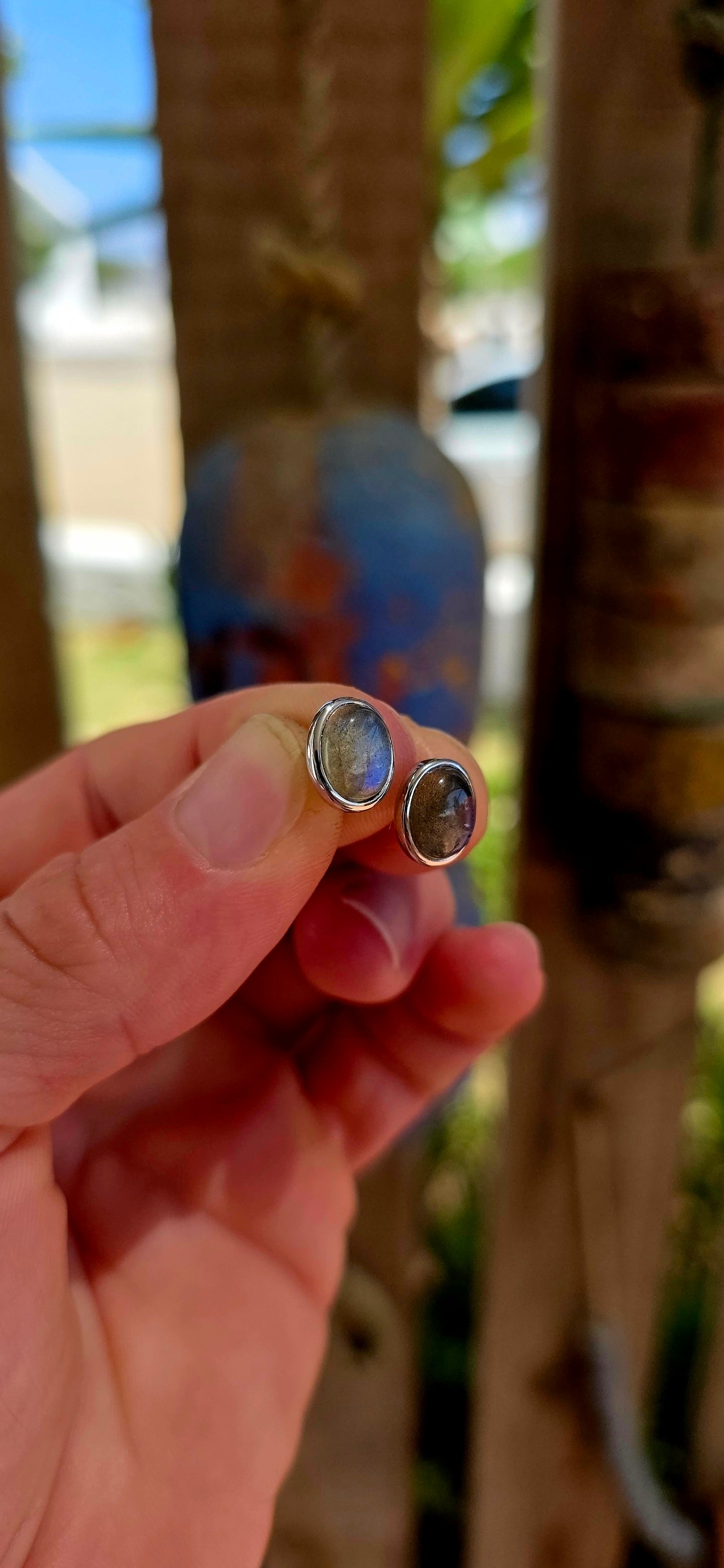This beautiful unisex pair of sterling silver stud earrings features glowing oval-cut labradorite cabochons, securely tube-set in sleek sterling silver bezels.