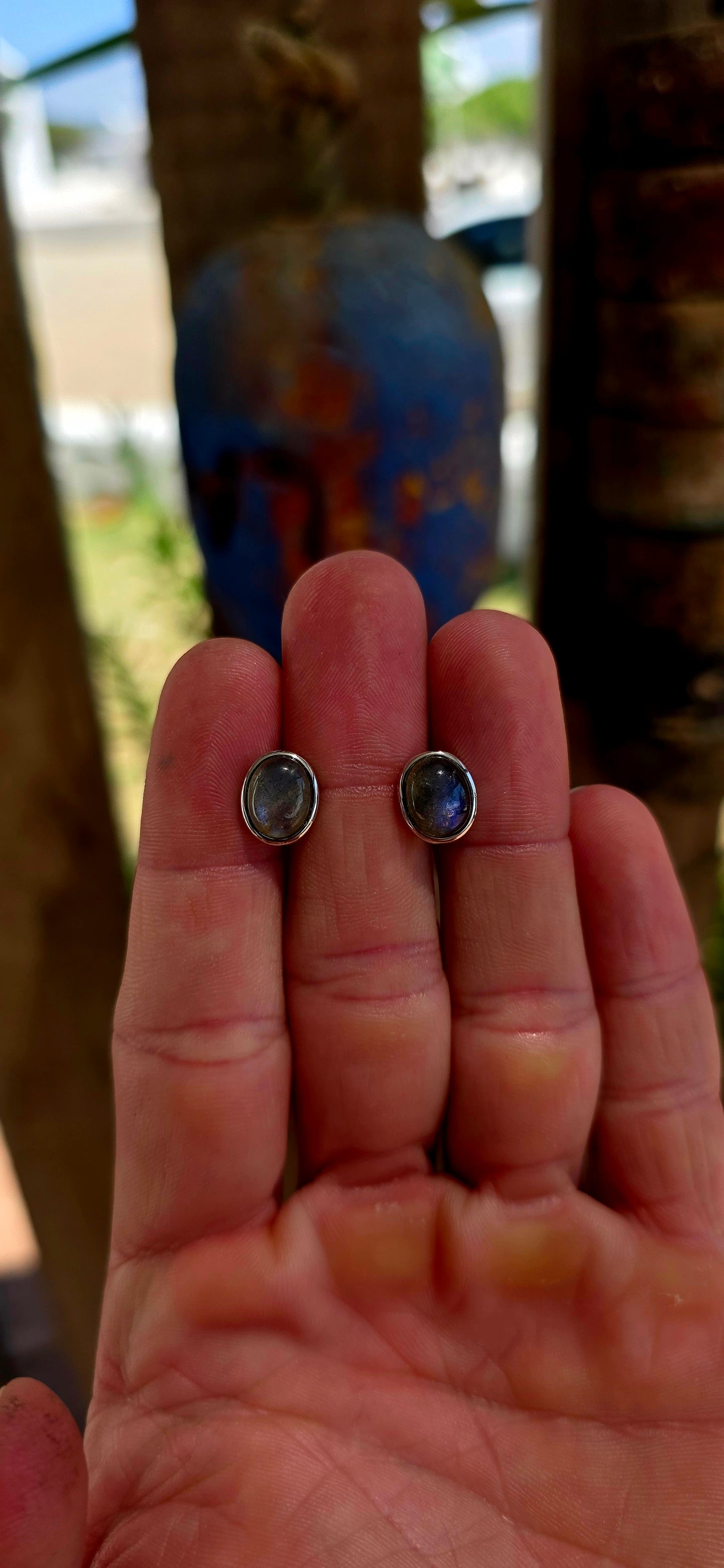 This beautiful unisex pair of sterling silver stud earrings features glowing oval-cut labradorite cabochons, securely tube-set in sleek sterling silver bezels.