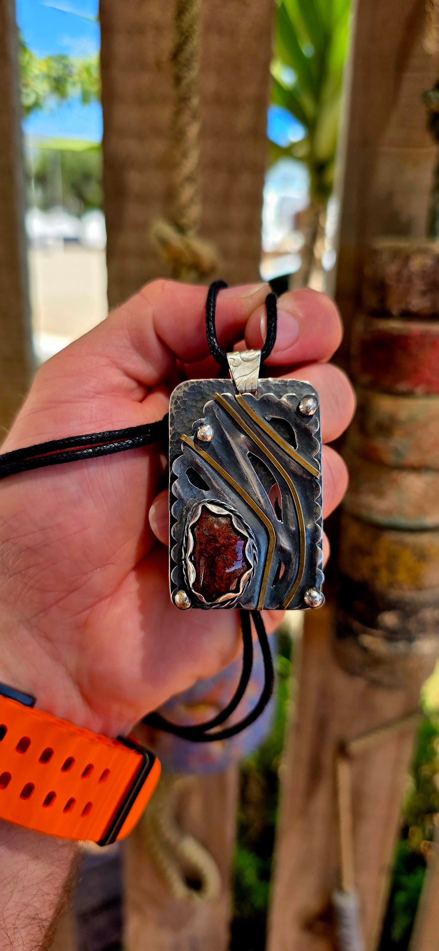 This large-scale artisan-made pendant is crafted in solid sterling silver and designed in a bold rectangular form with strong dimensional presence.
