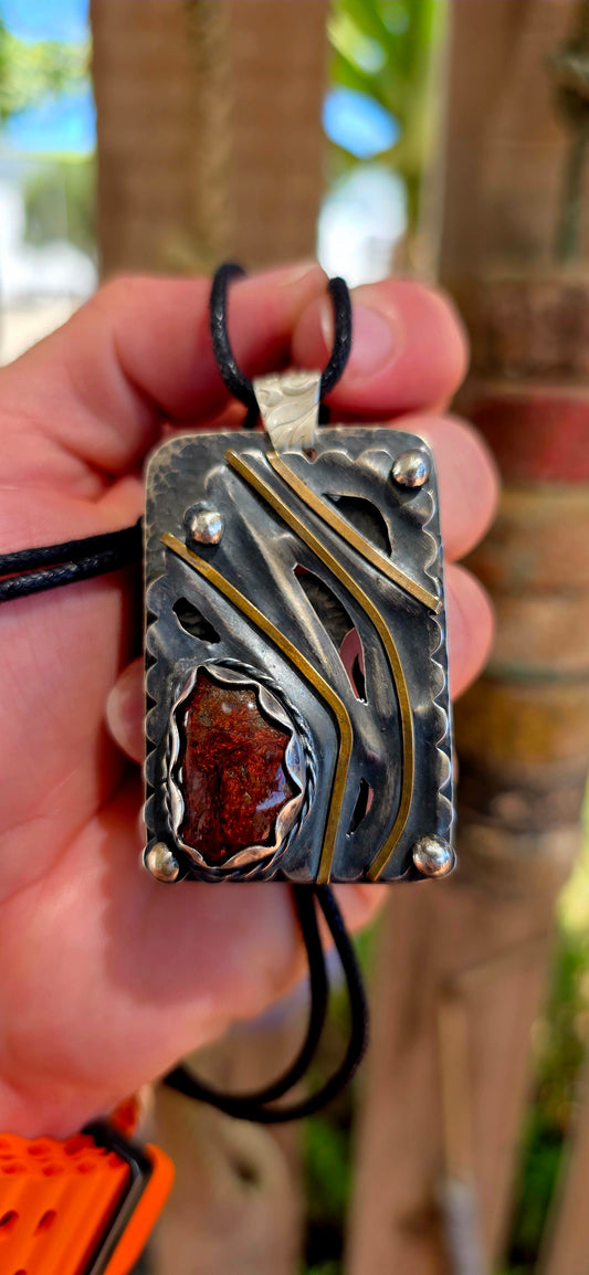 This large-scale artisan-made pendant is crafted in solid sterling silver and designed in a bold rectangular form with strong dimensional presence.