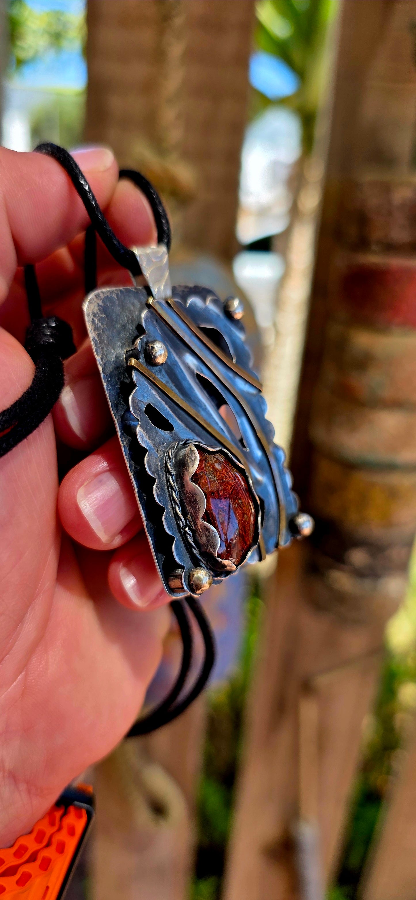 This large-scale artisan-made pendant is crafted in solid sterling silver and designed in a bold rectangular form with strong dimensional presence.