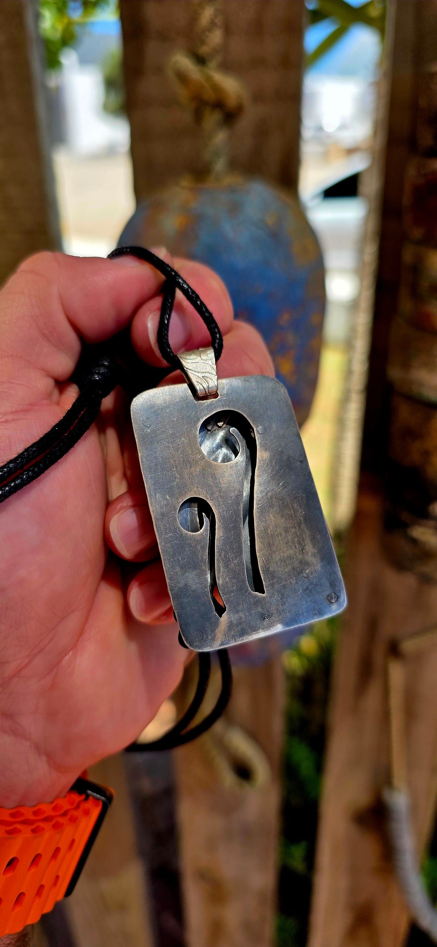This large-scale artisan-made pendant is crafted in solid sterling silver and designed in a bold rectangular form with strong dimensional presence.