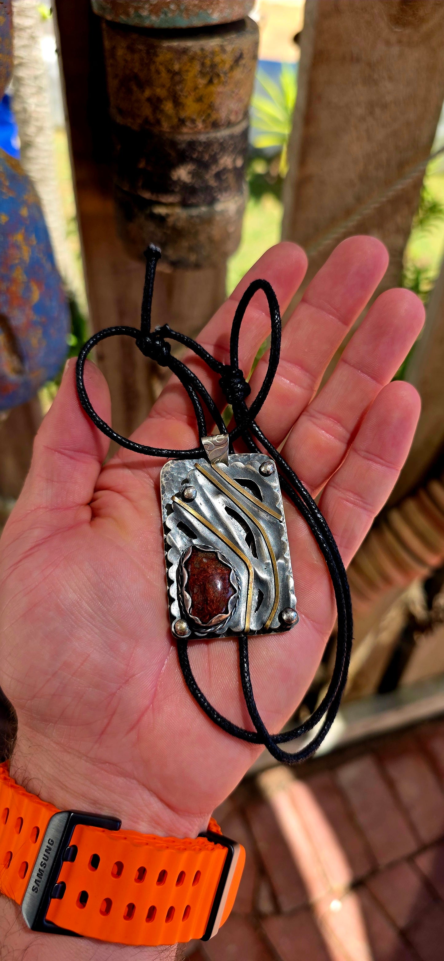 This large-scale artisan-made pendant is crafted in solid sterling silver and designed in a bold rectangular form with strong dimensional presence.