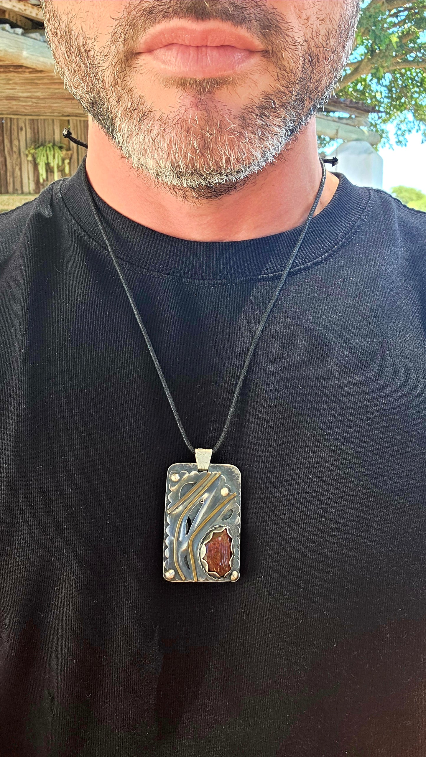 This large-scale artisan-made pendant is crafted in solid sterling silver and designed in a bold rectangular form with strong dimensional presence.