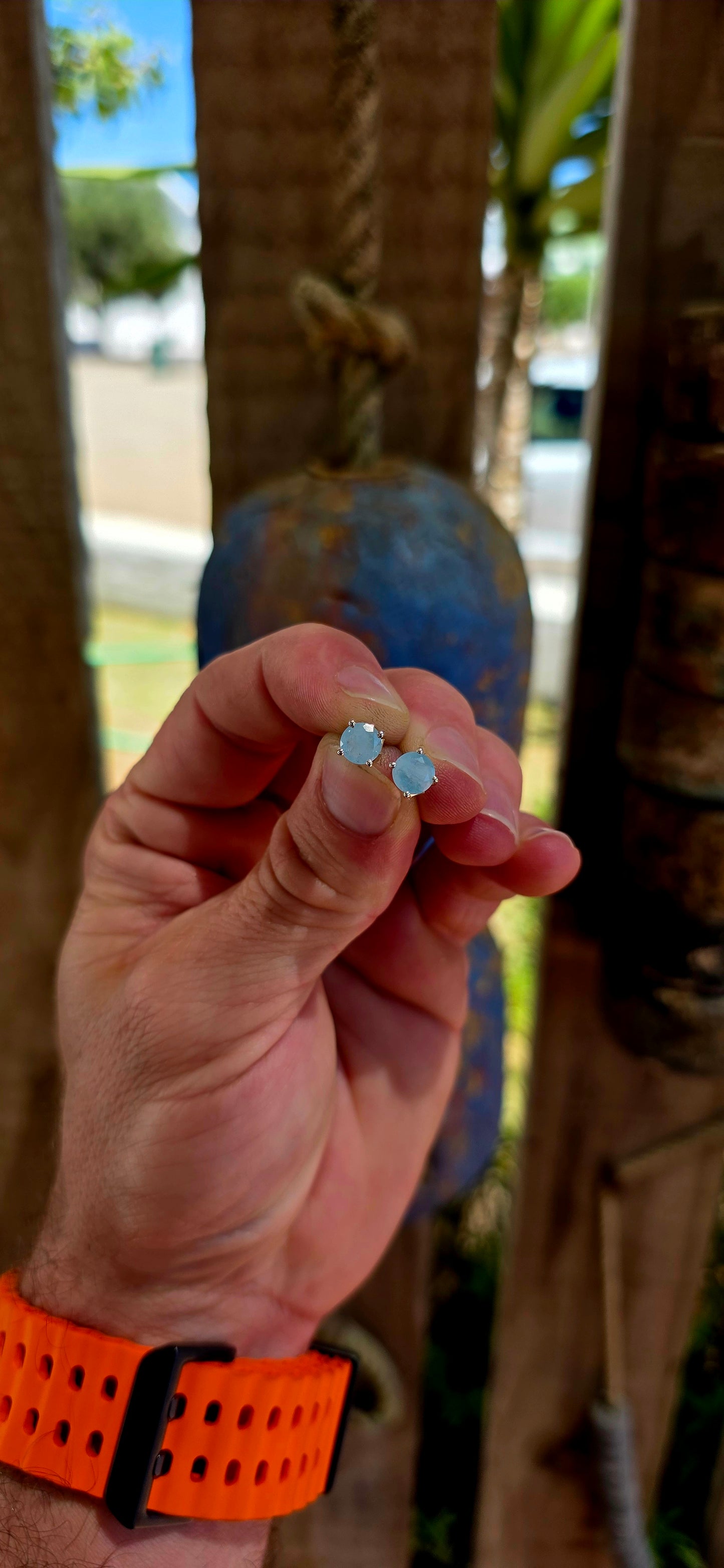 This striking pair of unisex sterling silver stud earrings features round faceted aquamarine gemstones in a soft milky / opaque tone — giving them a dreamy, sea-glass quality rather than a fully transparent sparkle.