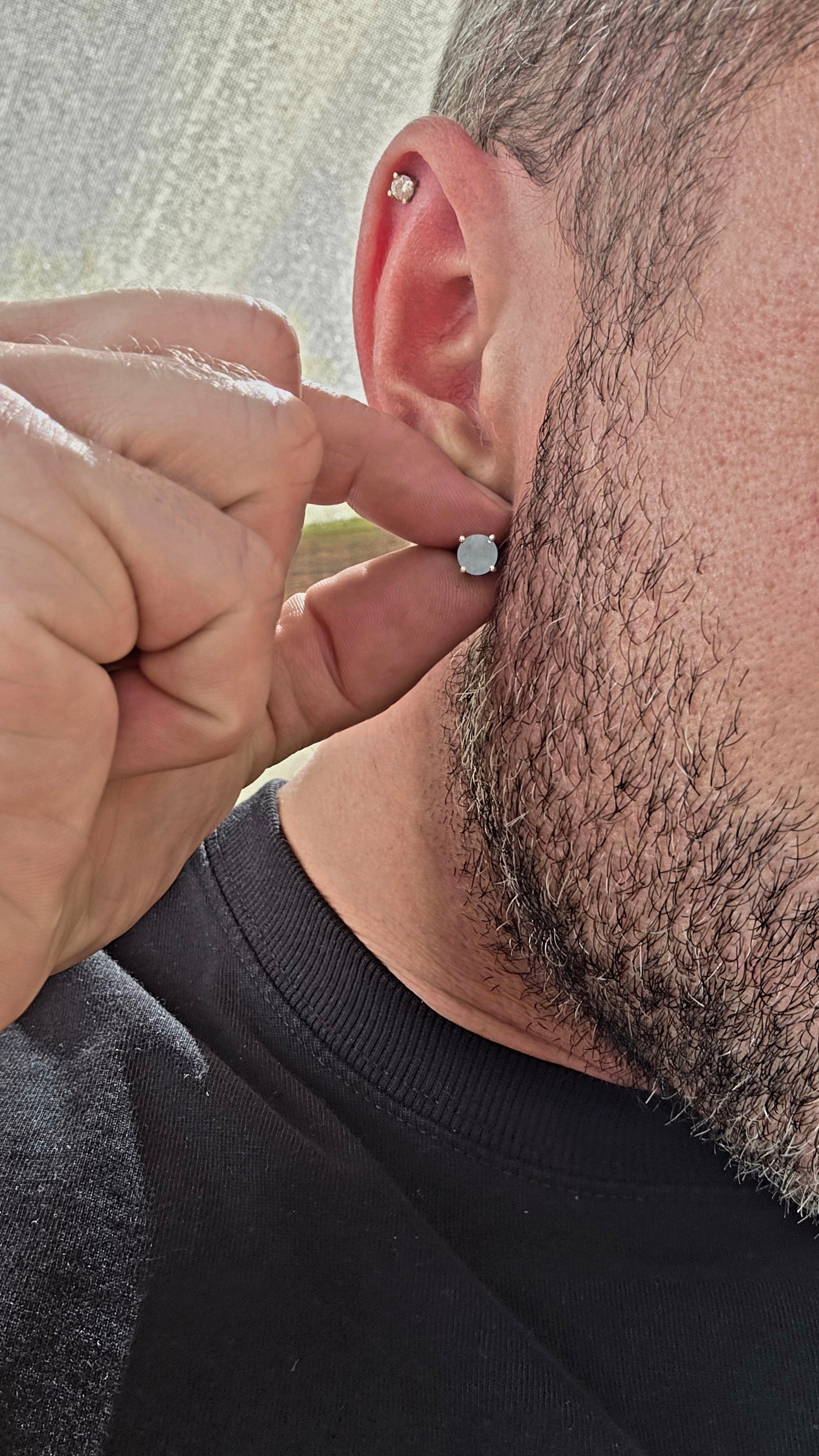 This striking pair of unisex sterling silver stud earrings features round faceted aquamarine gemstones in a soft milky / opaque tone — giving them a dreamy, sea-glass quality rather than a fully transparent sparkle.