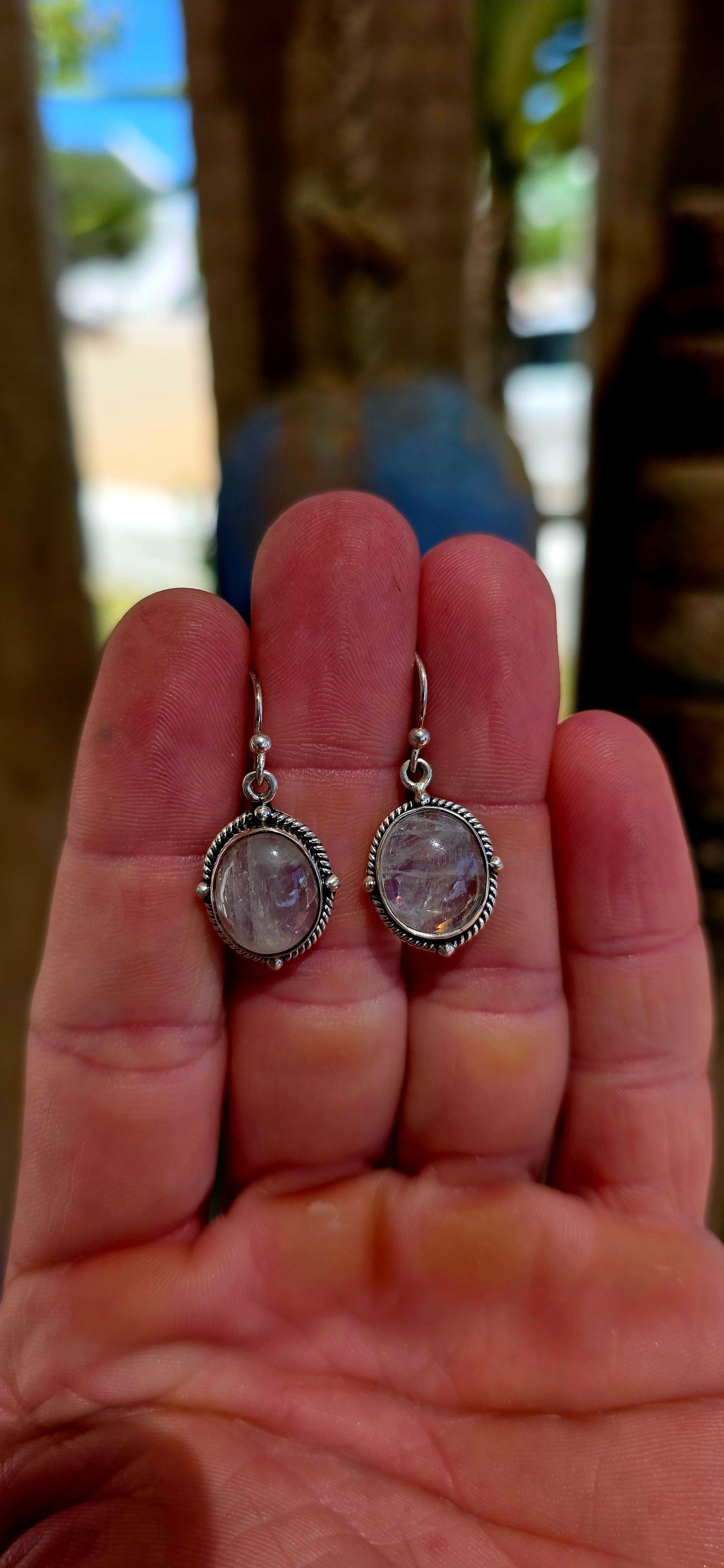 This beautiful pair of bohemian dangle earrings is crafted in solid sterling silver and set with glowing oval moonstone cabochons.
