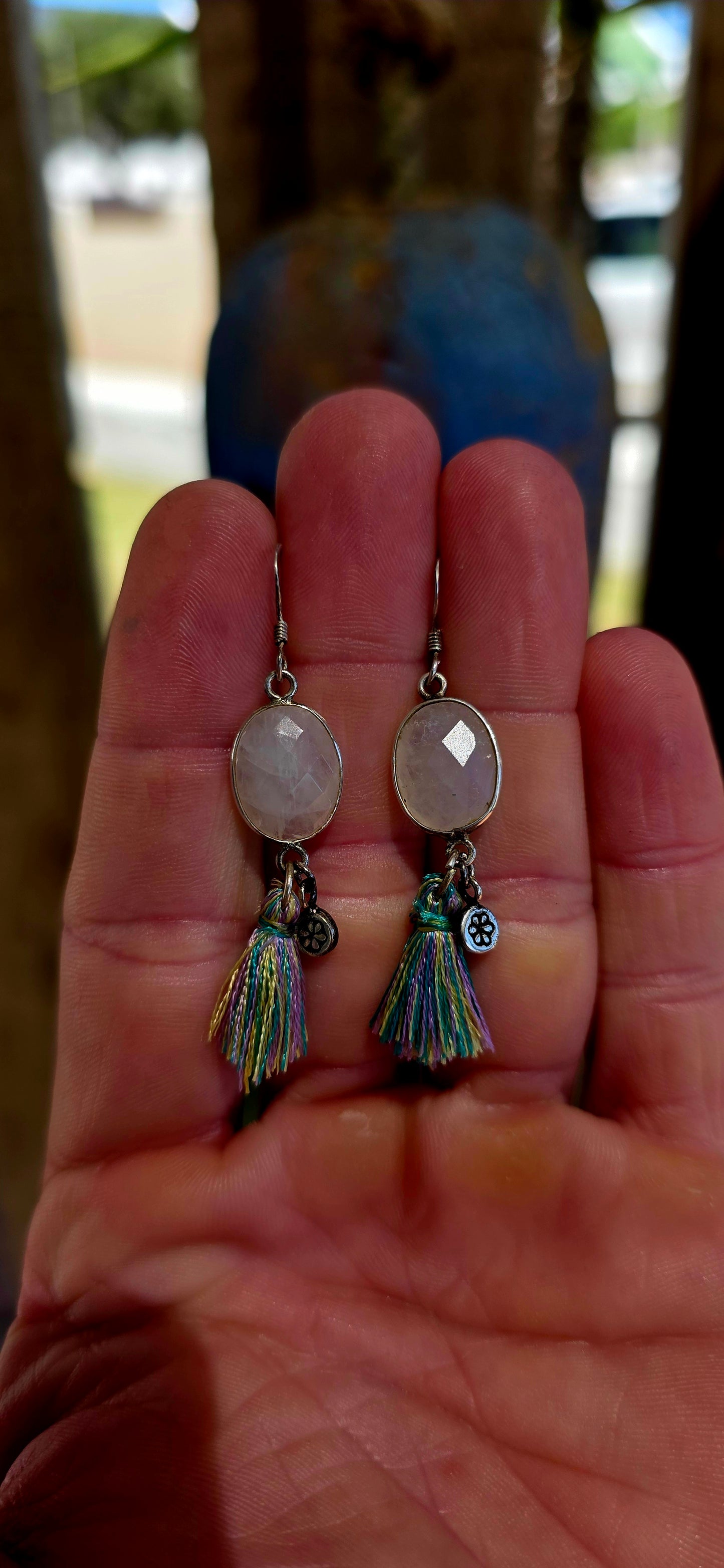 This beautiful pair of bohemian drop earrings is crafted in sterling silver and features oval faceted moonstone gemstones, securely tube-set within smooth silver frames.
