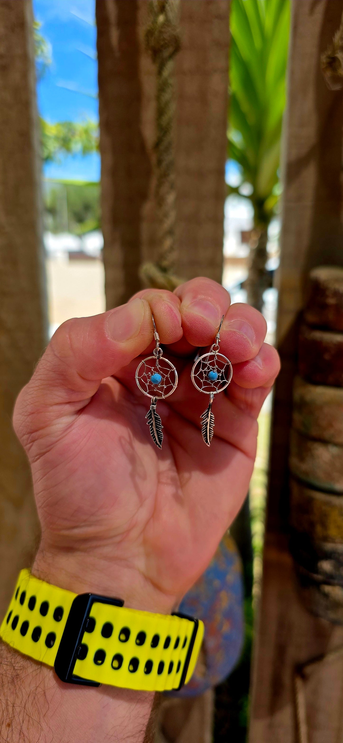 This charming pair of sterling silver earrings is crafted in the shape of miniature dreamcatchers — beautifully detailed in fine wirework to mimic the traditional web design.