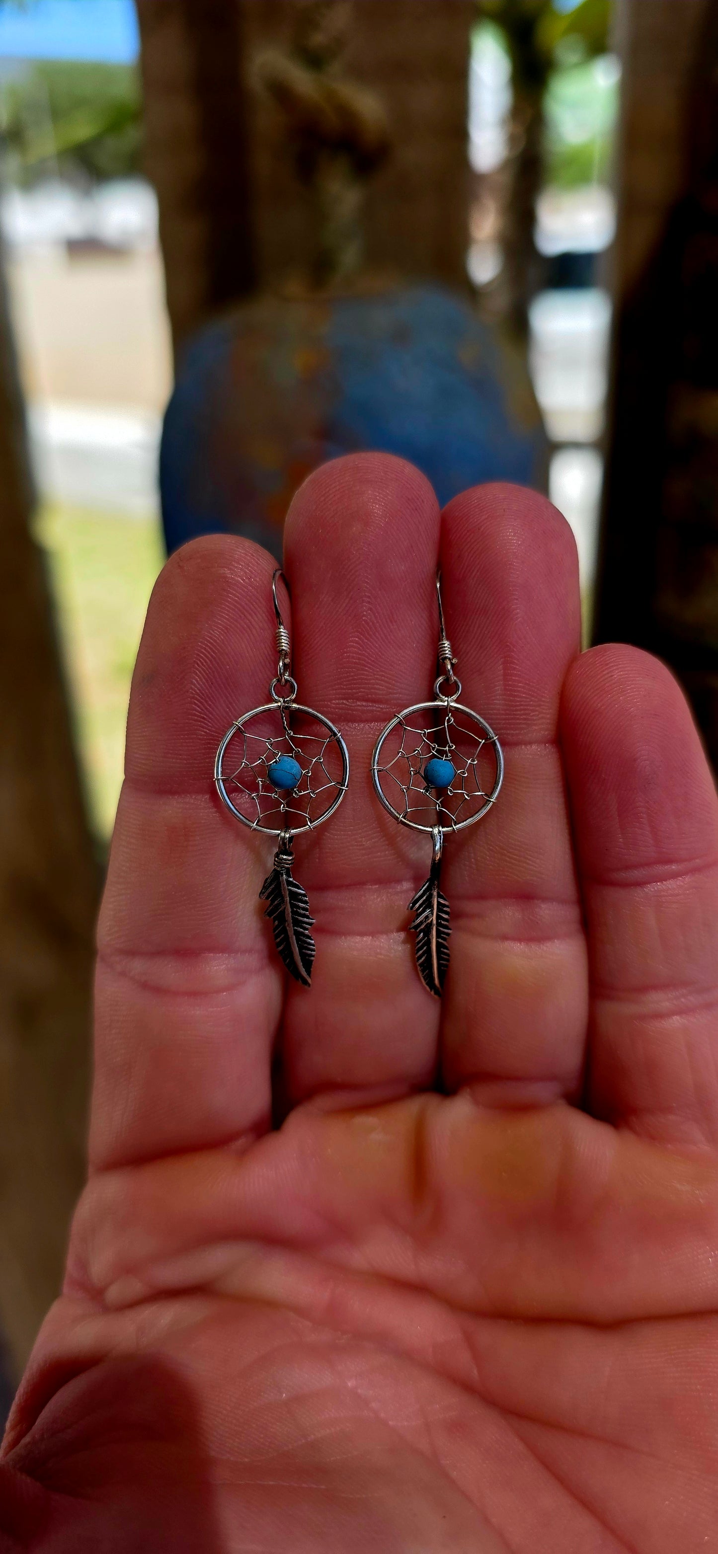 This charming pair of sterling silver earrings is crafted in the shape of miniature dreamcatchers — beautifully detailed in fine wirework to mimic the traditional web design.