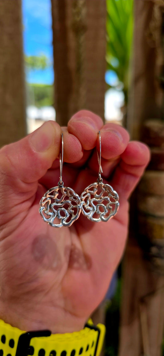This striking pair of artisan-made earrings is crafted in solid sterling silver and designed in an abstract floral-inspired form — but not your traditional flower.