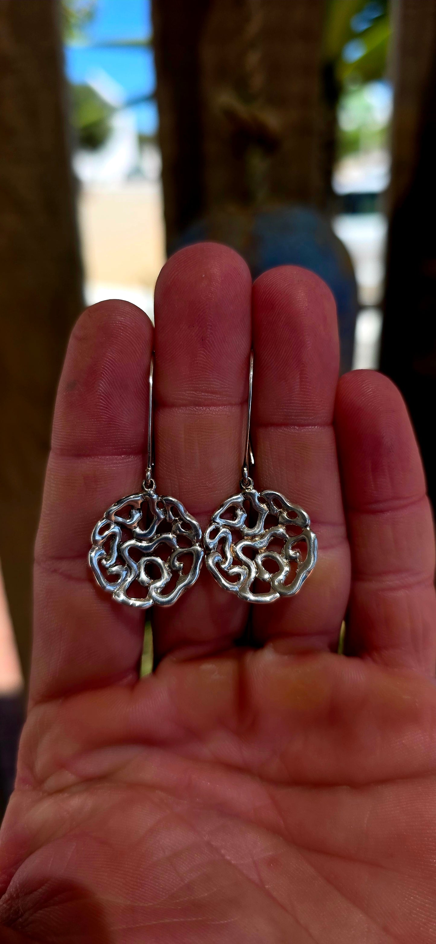 This striking pair of artisan-made earrings is crafted in solid sterling silver and designed in an abstract floral-inspired form — but not your traditional flower.