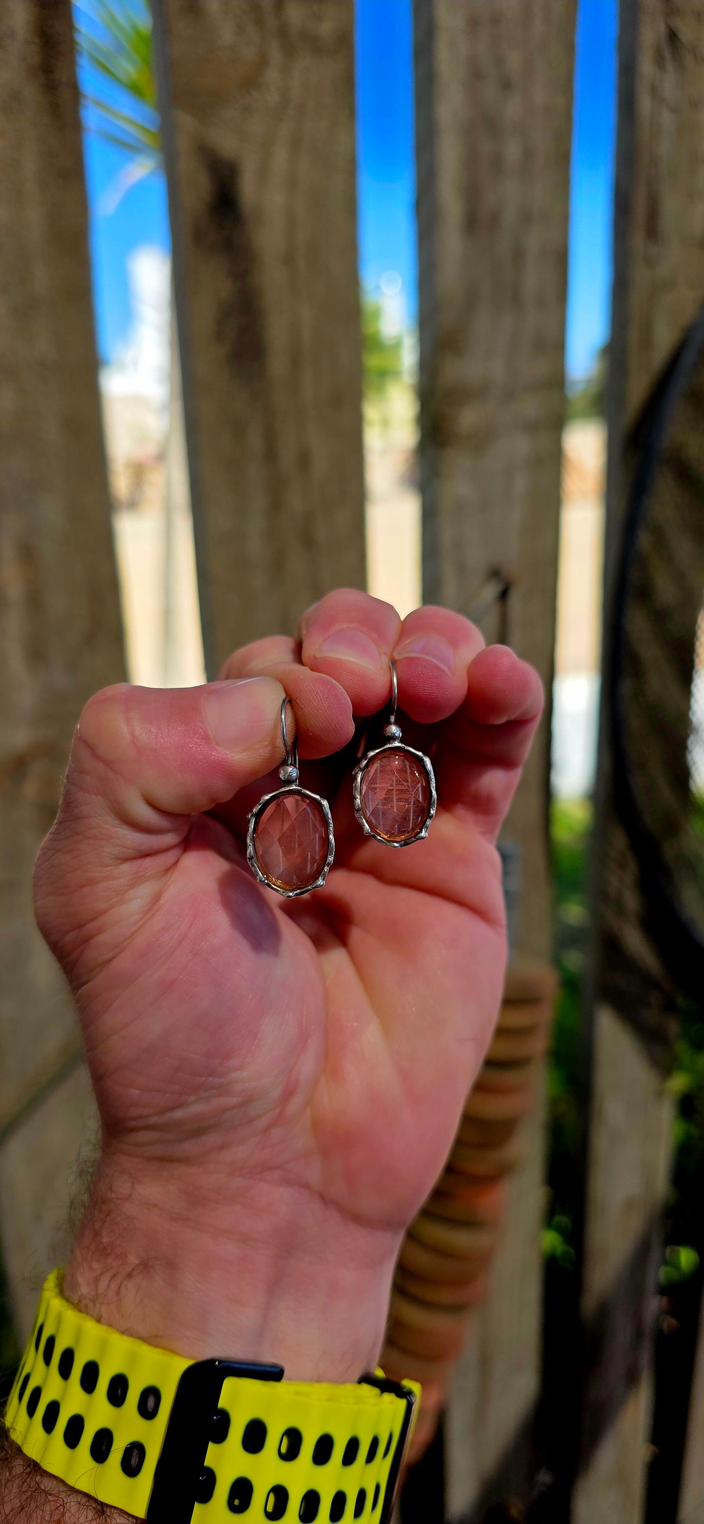 These beautiful artisan-made designer earrings are crafted in sterling silver and feature luminous faceted oval-cut strawberry quartz gemstones in a warm, soft rose hue.