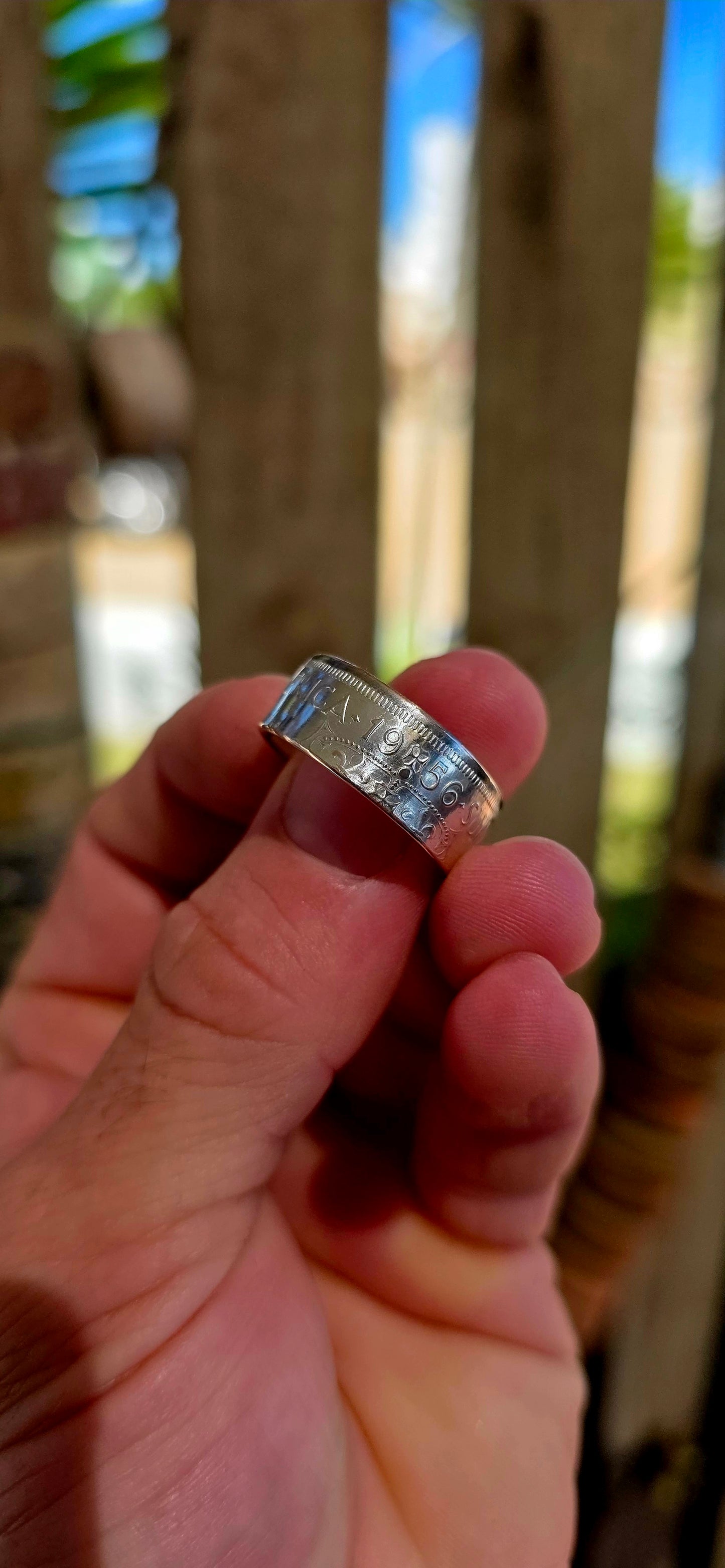 This fantastic artisan-made coin ring has been crafted from an authentic South African 2½ Shilling coin dated 1956, struck in .500 silver during the Union of South Africa era.