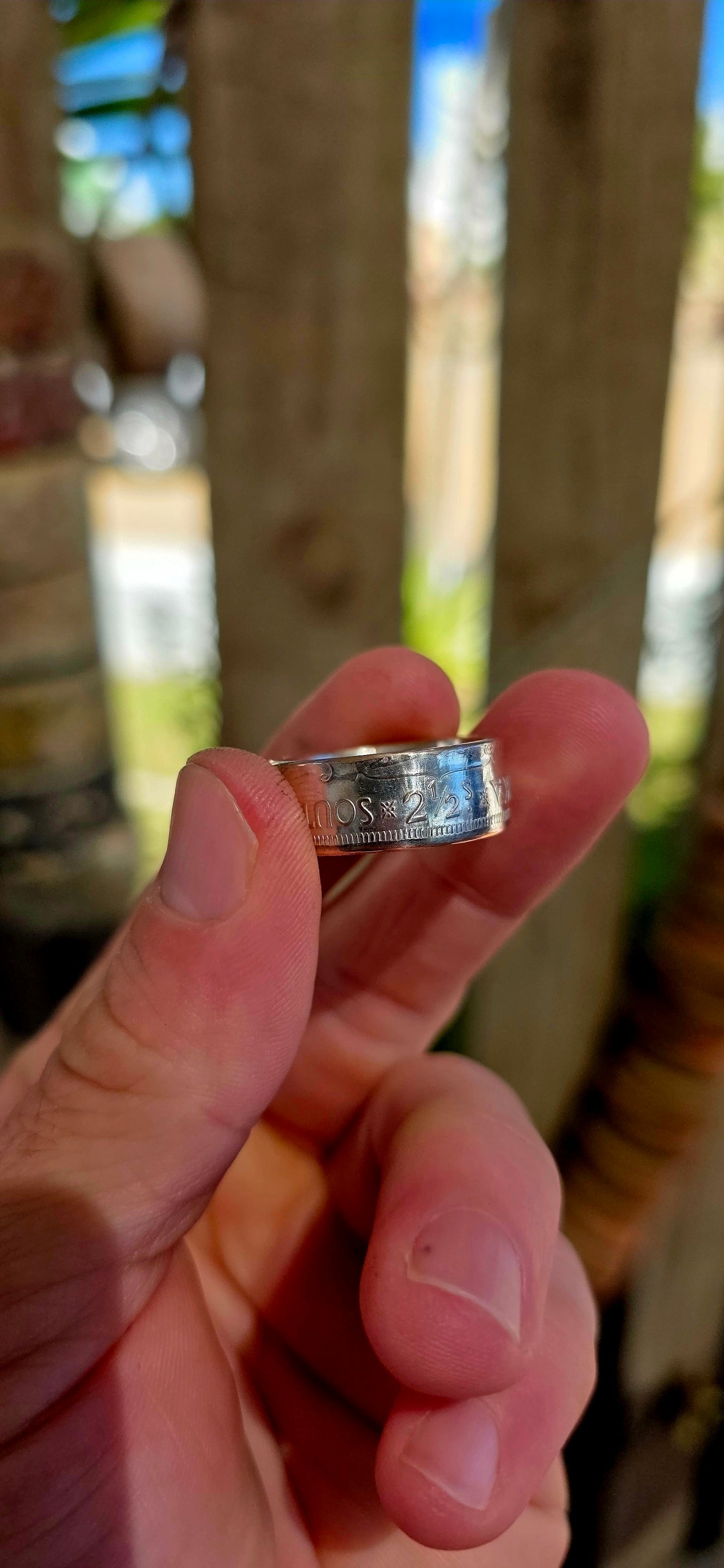 This fantastic artisan-made coin ring has been crafted from an authentic South African 2½ Shilling coin dated 1956, struck in .500 silver during the Union of South Africa era.