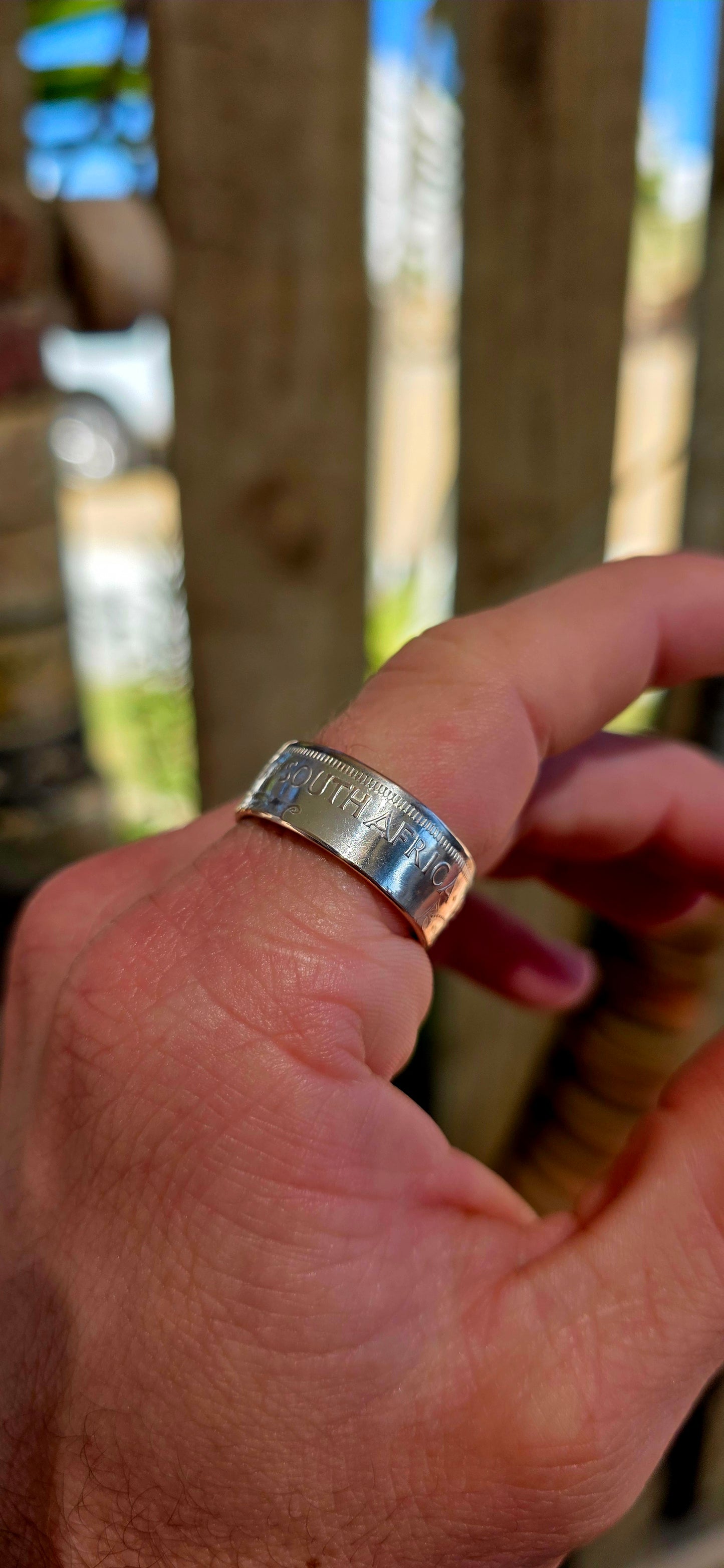 This fantastic artisan-made coin ring has been crafted from an authentic South African 2½ Shilling coin dated 1956, struck in .500 silver during the Union of South Africa era.