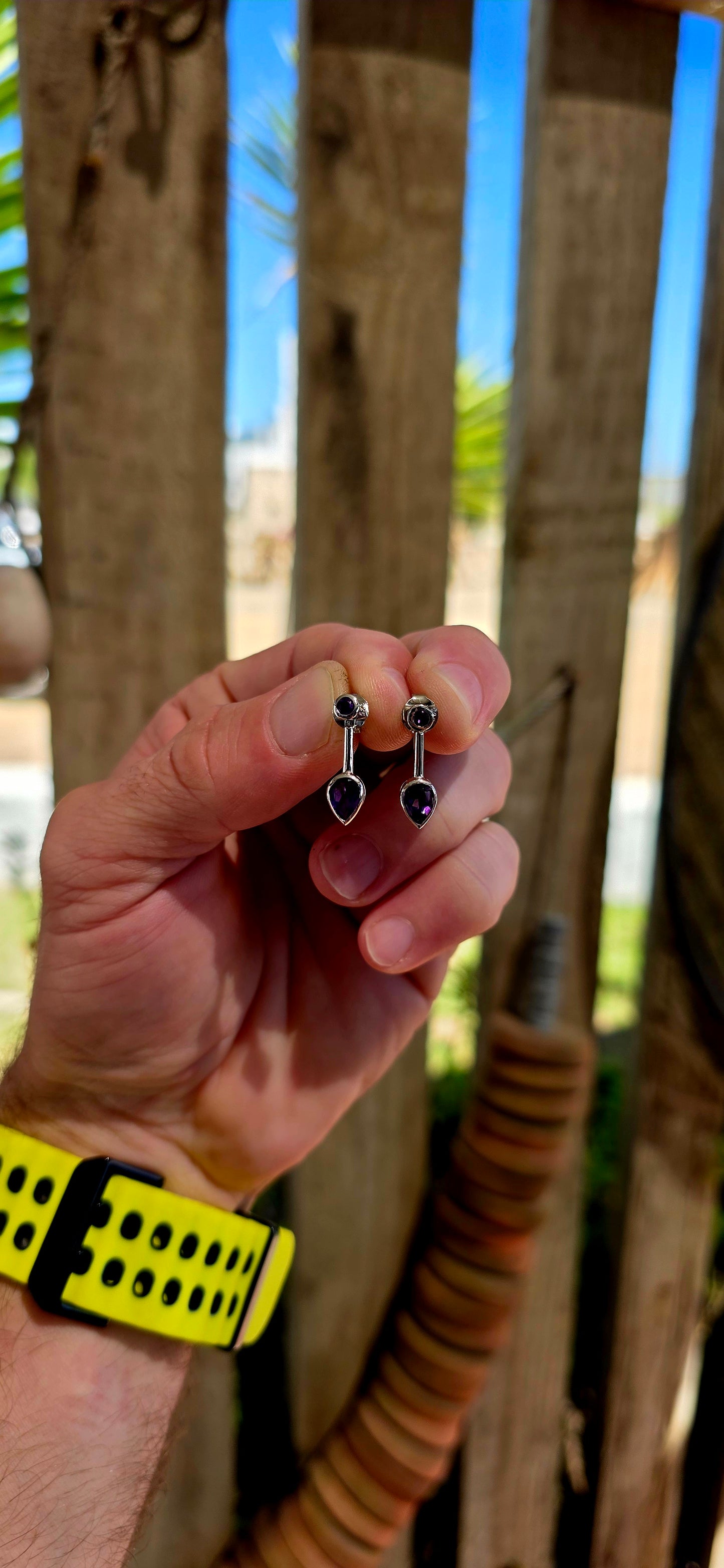This beautiful pair of modernist-style drop earrings is crafted in solid sterling silver, featuring a sleek geometric design that perfectly showcases the rich colour of amethyst gemstones.