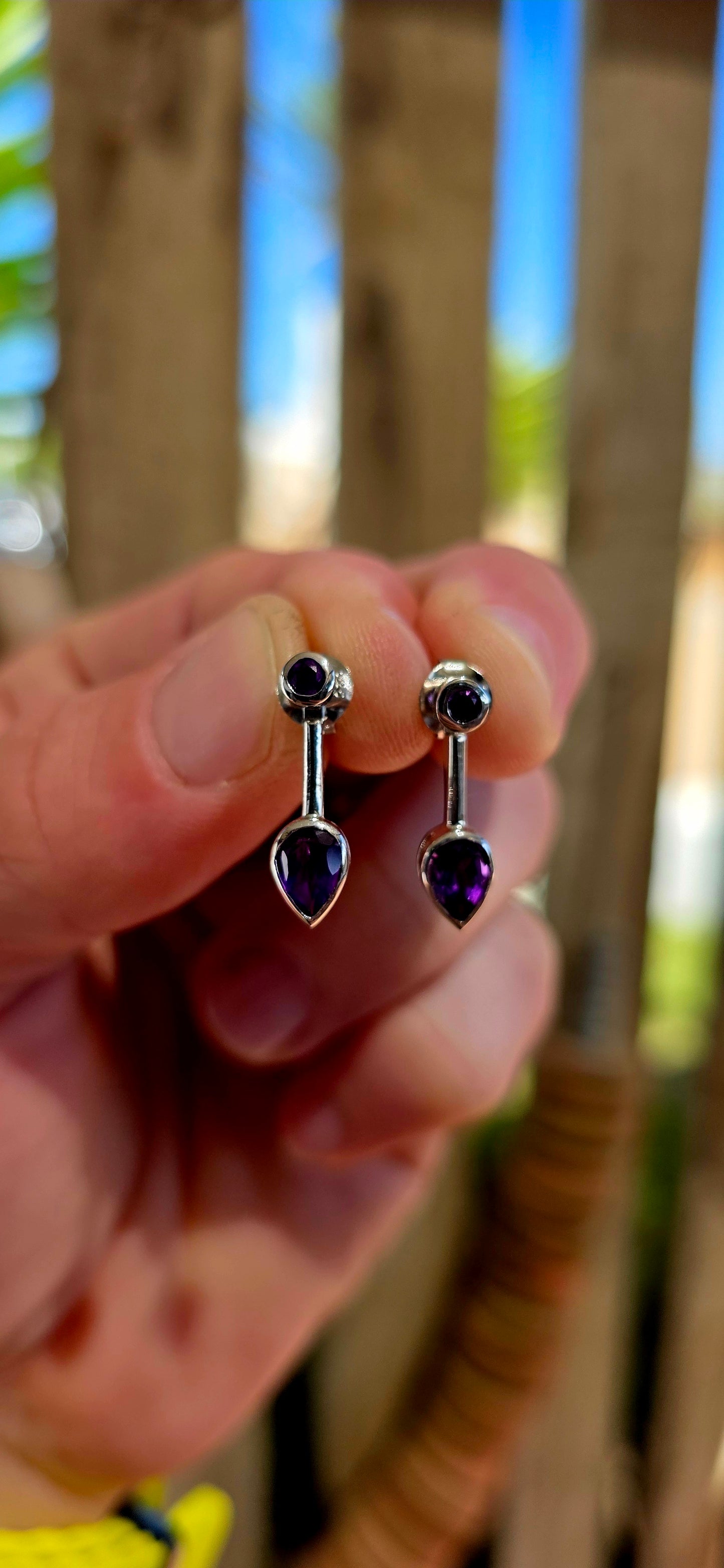 This beautiful pair of modernist-style drop earrings is crafted in solid sterling silver, featuring a sleek geometric design that perfectly showcases the rich colour of amethyst gemstones.