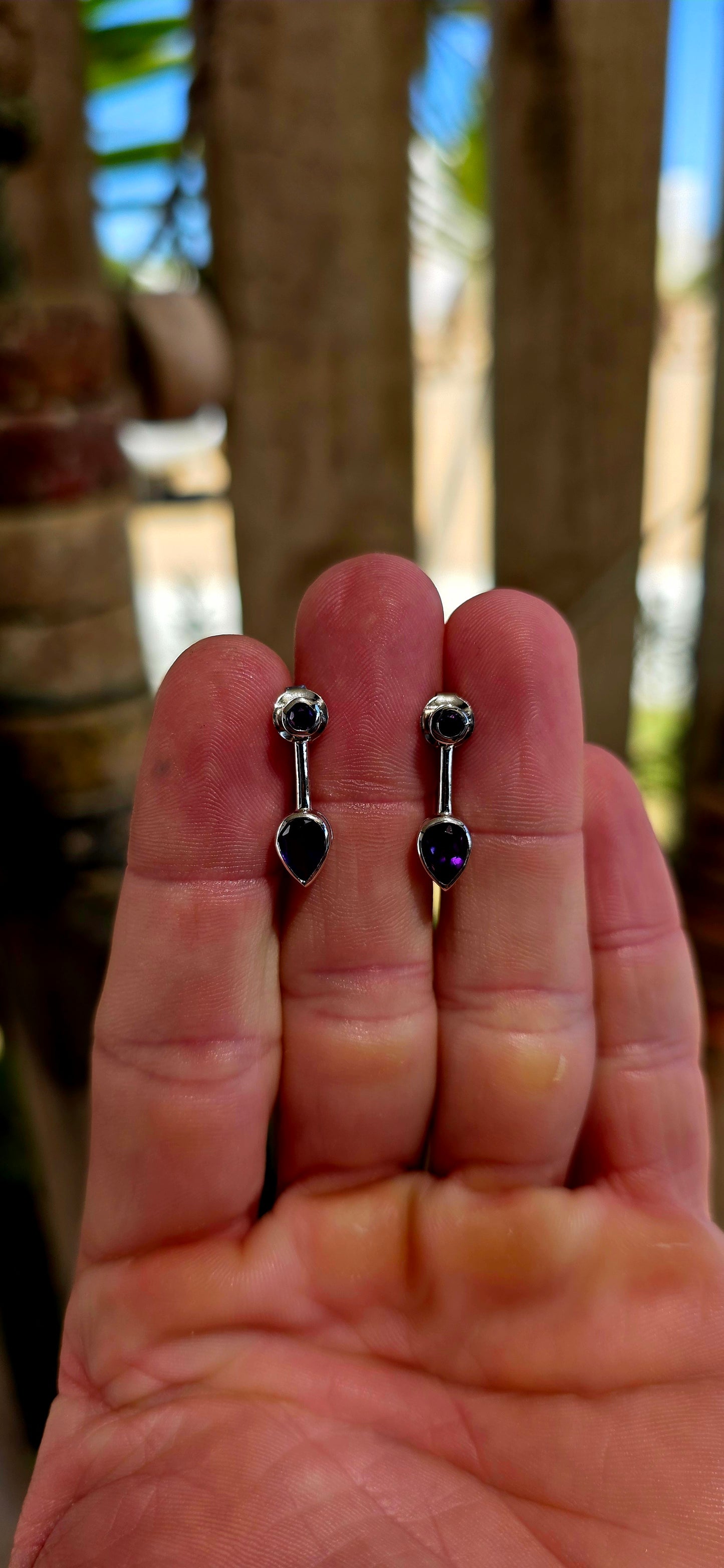 This beautiful pair of modernist-style drop earrings is crafted in solid sterling silver, featuring a sleek geometric design that perfectly showcases the rich colour of amethyst gemstones.