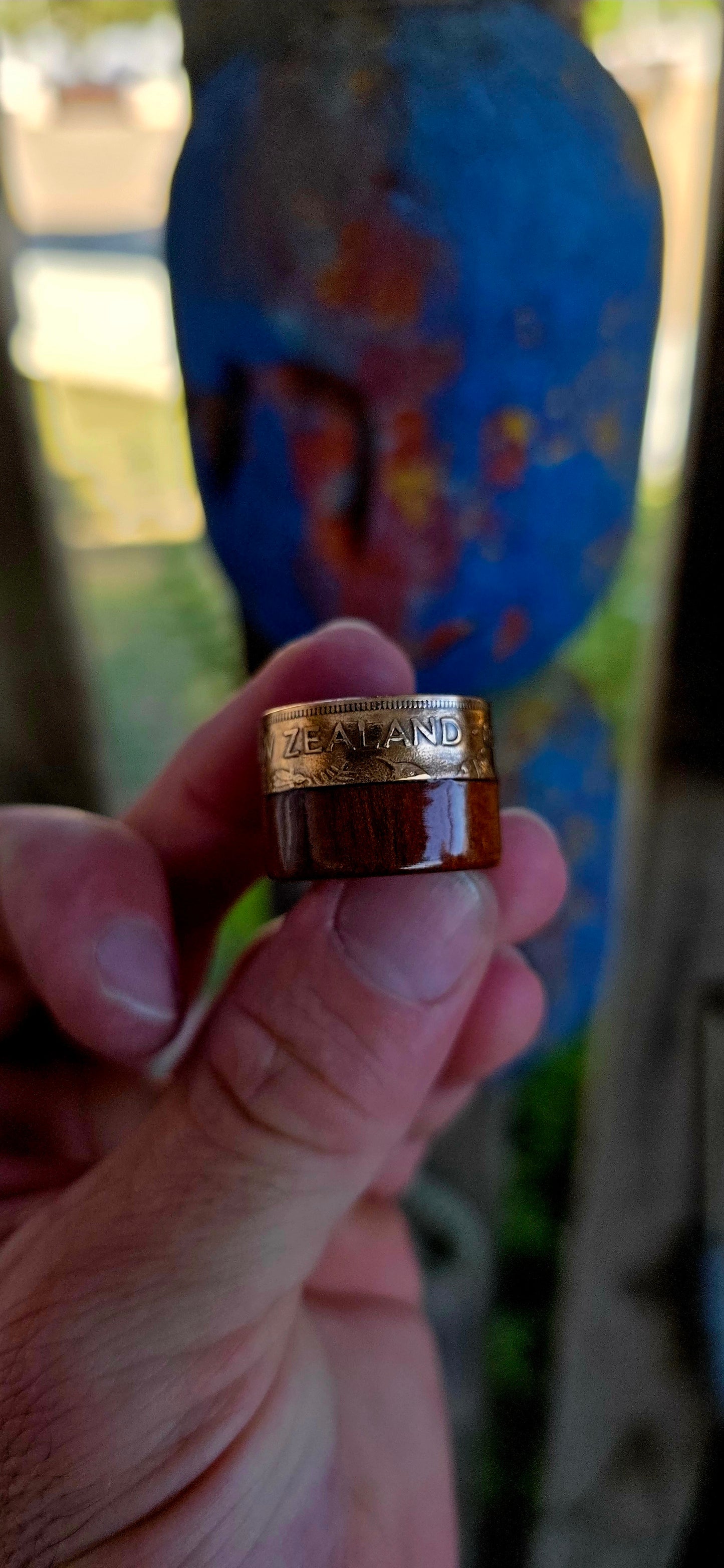 This striking extra-wide artisan statement ring combines natural materials with historic coinage, resulting in a piece that feels earthy and adventurous — the kind of ring that looks like it belongs on a treasure hunter’s hand.