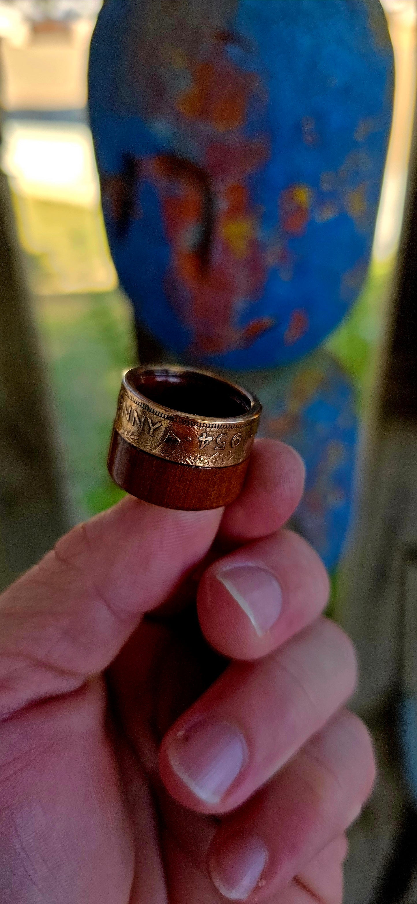 This striking extra-wide artisan statement ring combines natural materials with historic coinage, resulting in a piece that feels earthy and adventurous — the kind of ring that looks like it belongs on a treasure hunter’s hand.