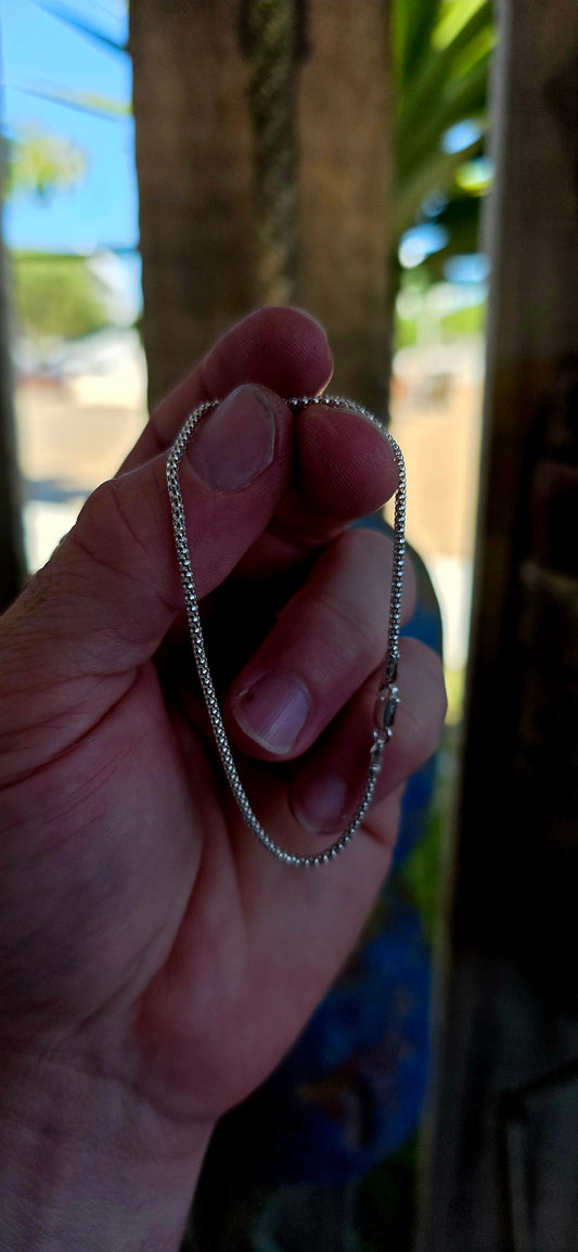 This elegant unisex bracelet is crafted in solid sterling silver and designed in the classic popcorn link chain style — a beautifully fluid construction made up of tightly interwoven rounded links that create a soft, textured surface.