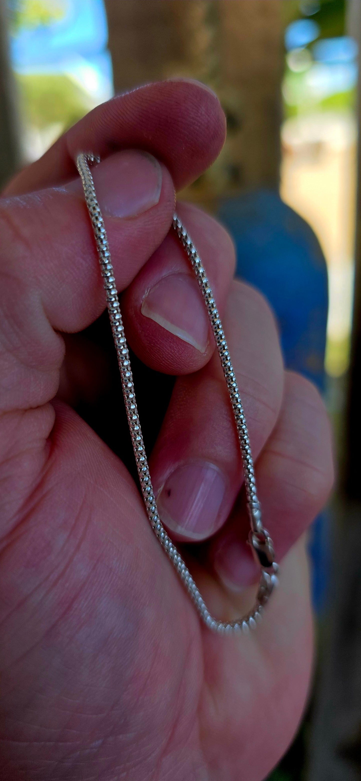 This elegant unisex bracelet is crafted in solid sterling silver and designed in the classic popcorn link chain style — a beautifully fluid construction made up of tightly interwoven rounded links that create a soft, textured surface.