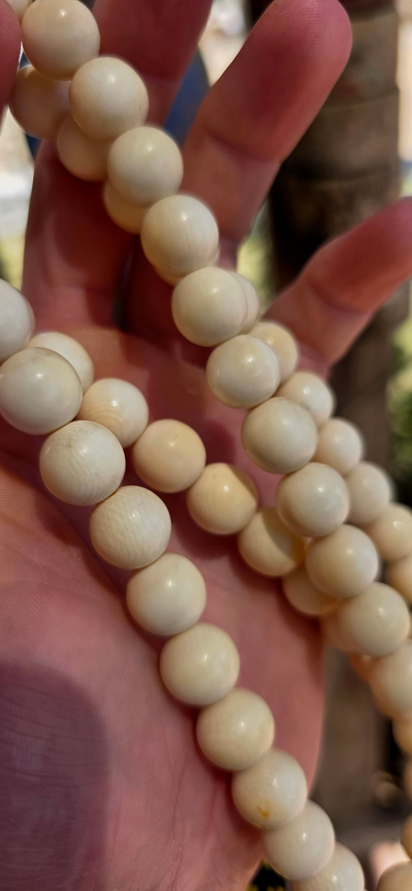 This beautiful antique necklace features a generous strand of perfectly round hand-carved pre-ban ivory beads, forming a timeless and sophisticated piece with remarkable presence.