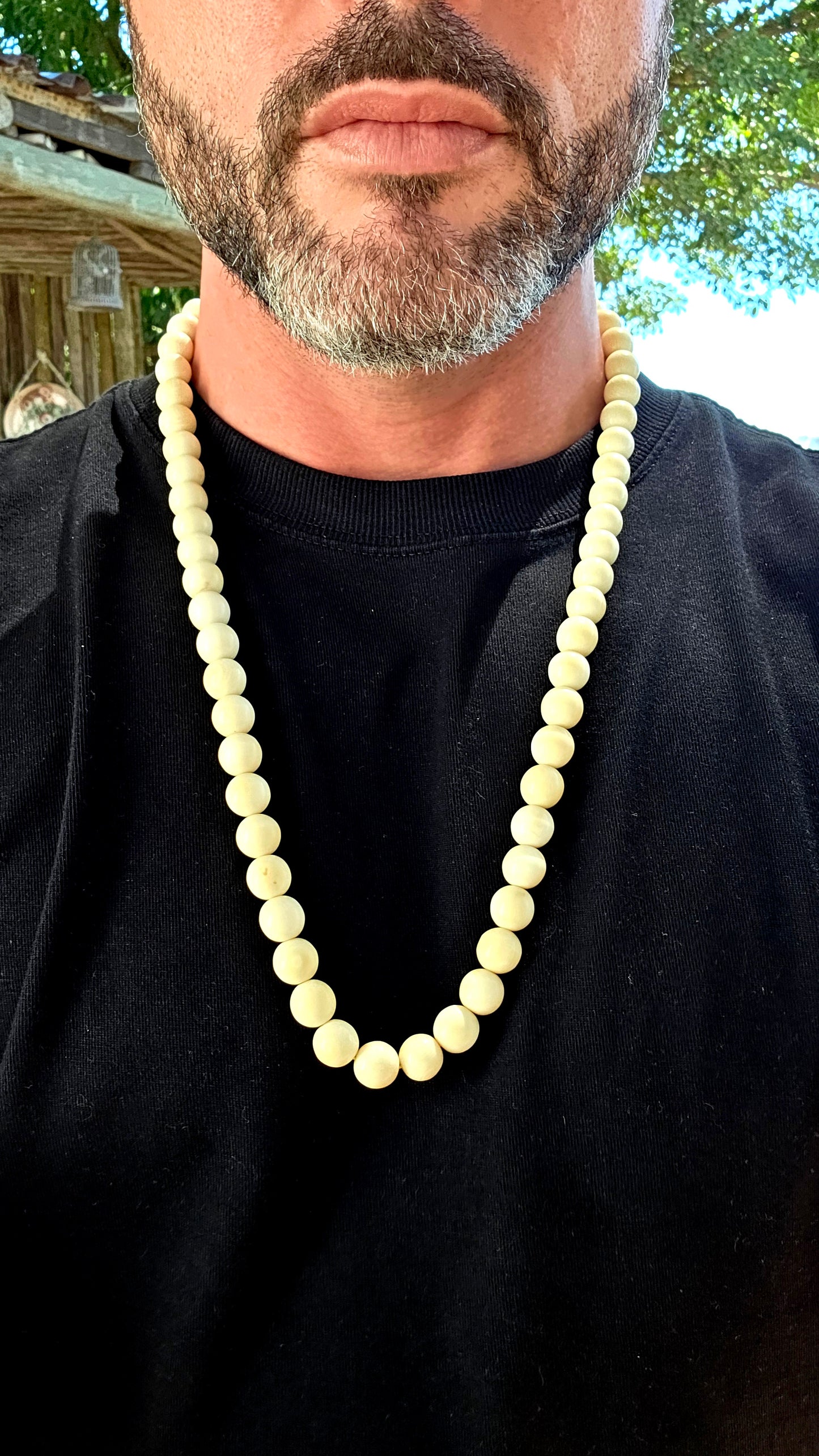 This beautiful antique necklace features a generous strand of perfectly round hand-carved pre-ban ivory beads, forming a timeless and sophisticated piece with remarkable presence.