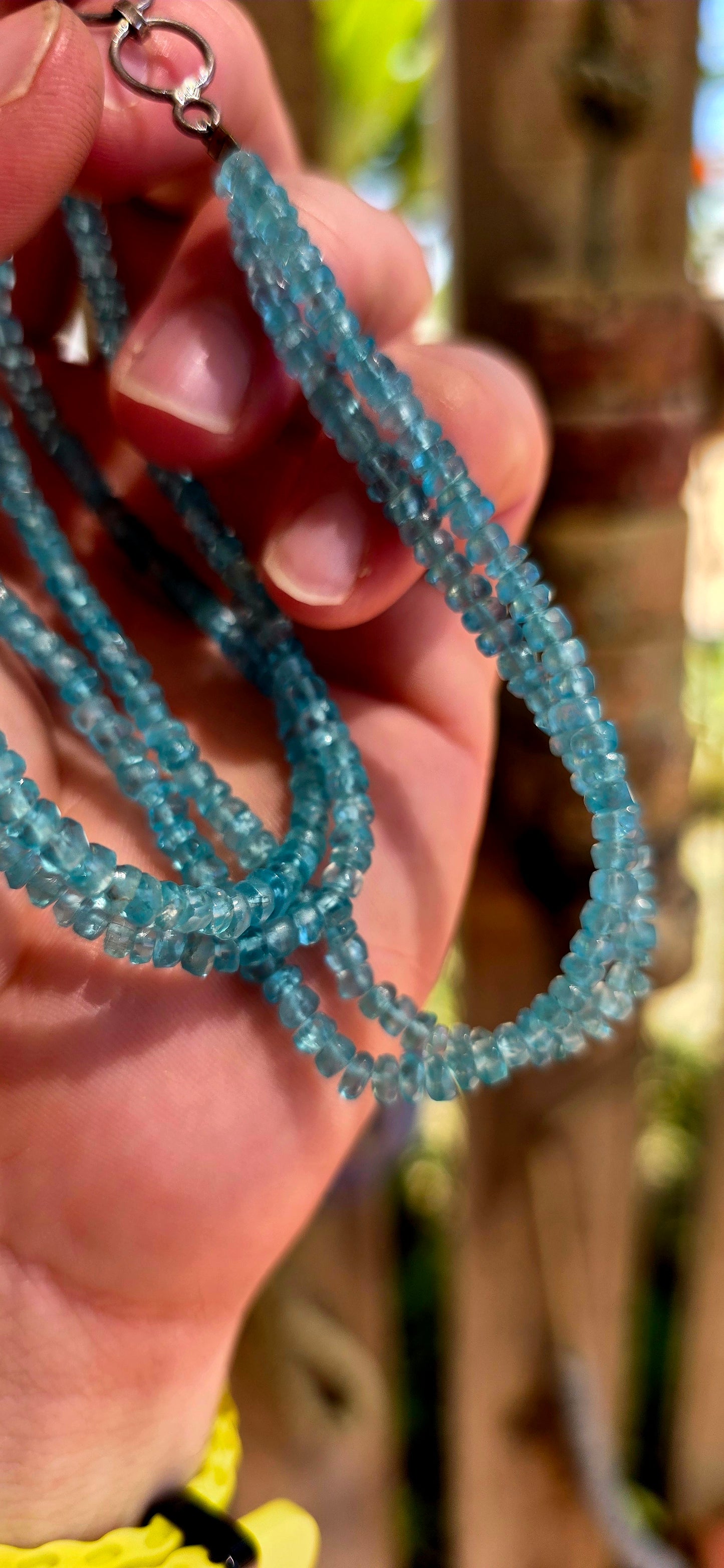 This beautiful necklace is crafted from two strands of faceted blue apatite gemstone beads, each bead cut into tiny rondelles that catch the light with a subtle sparkle.