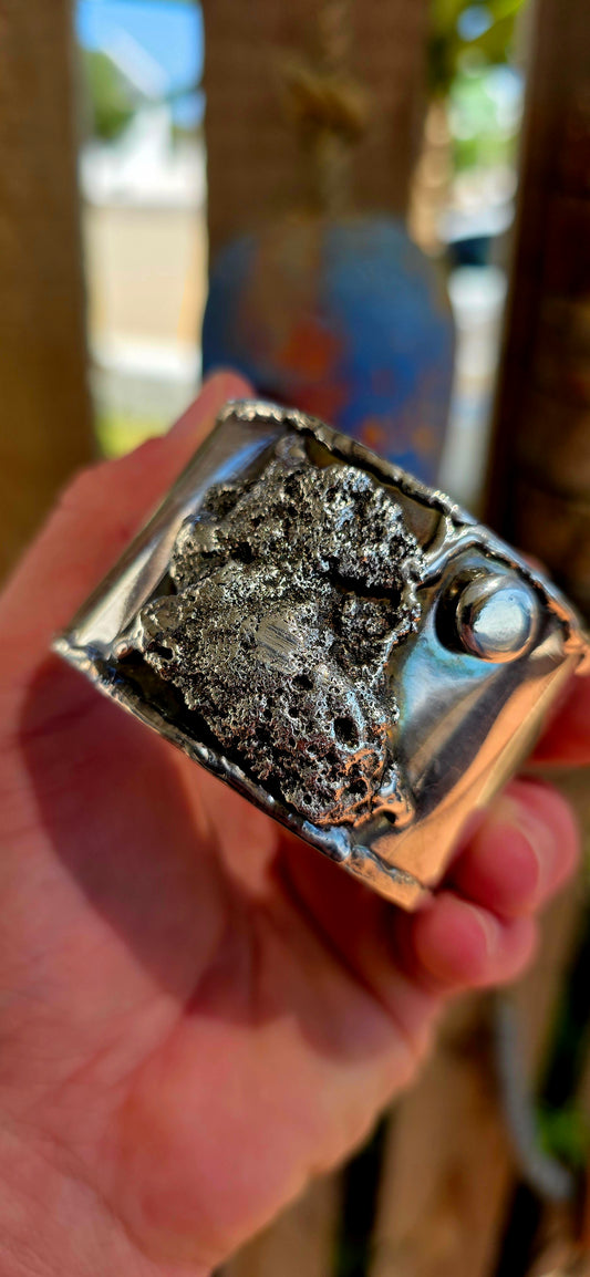 A striking and powerful vintage cuff bangle from the 1970s, crafted in silver-plated metal and embodying the unmistakable spirit of modernist brutalist design—where jewellery becomes wearable sculpture.