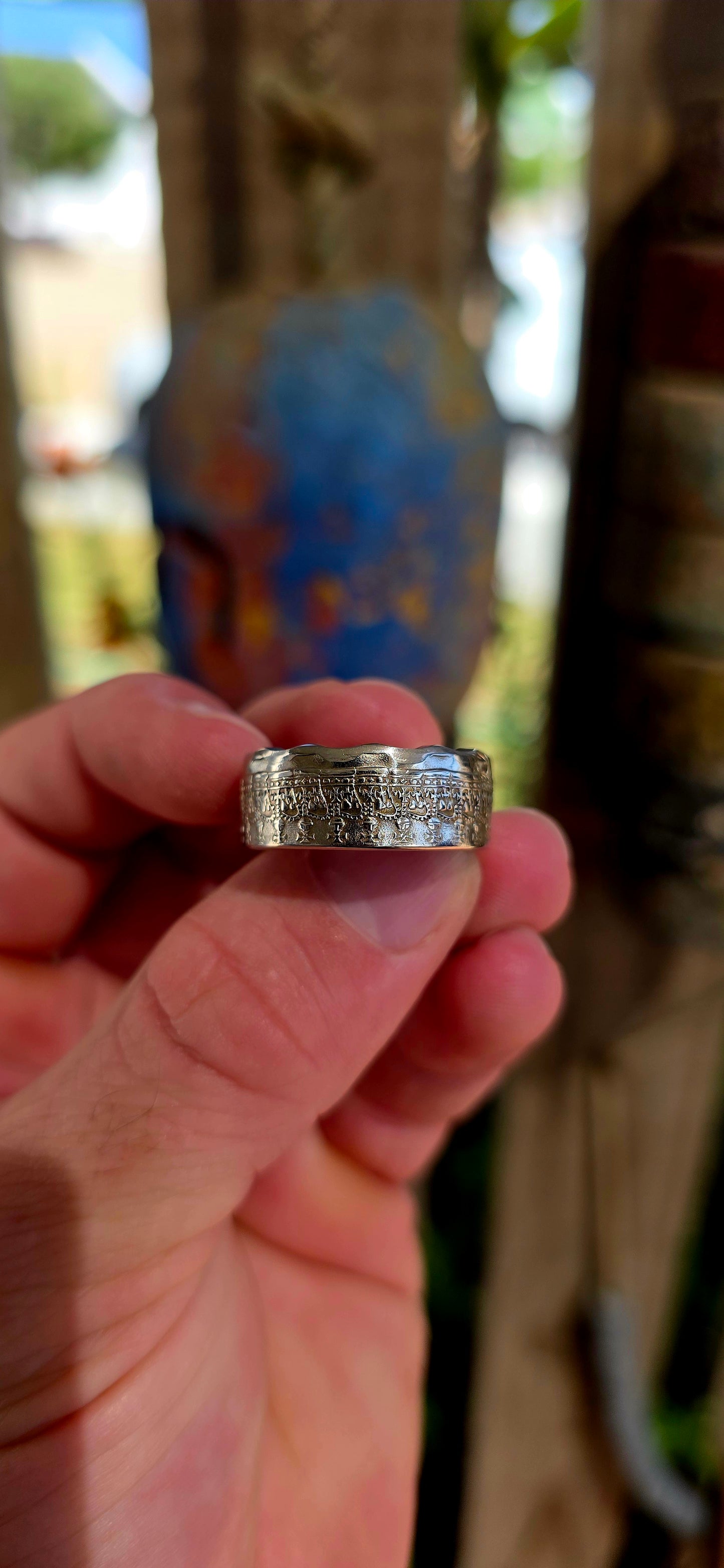 A bold, artisan-crafted coin ring, expertly formed from an authentic 1977 Australian 50 cent coin, struck in nickel and featuring Queen Elizabeth II.