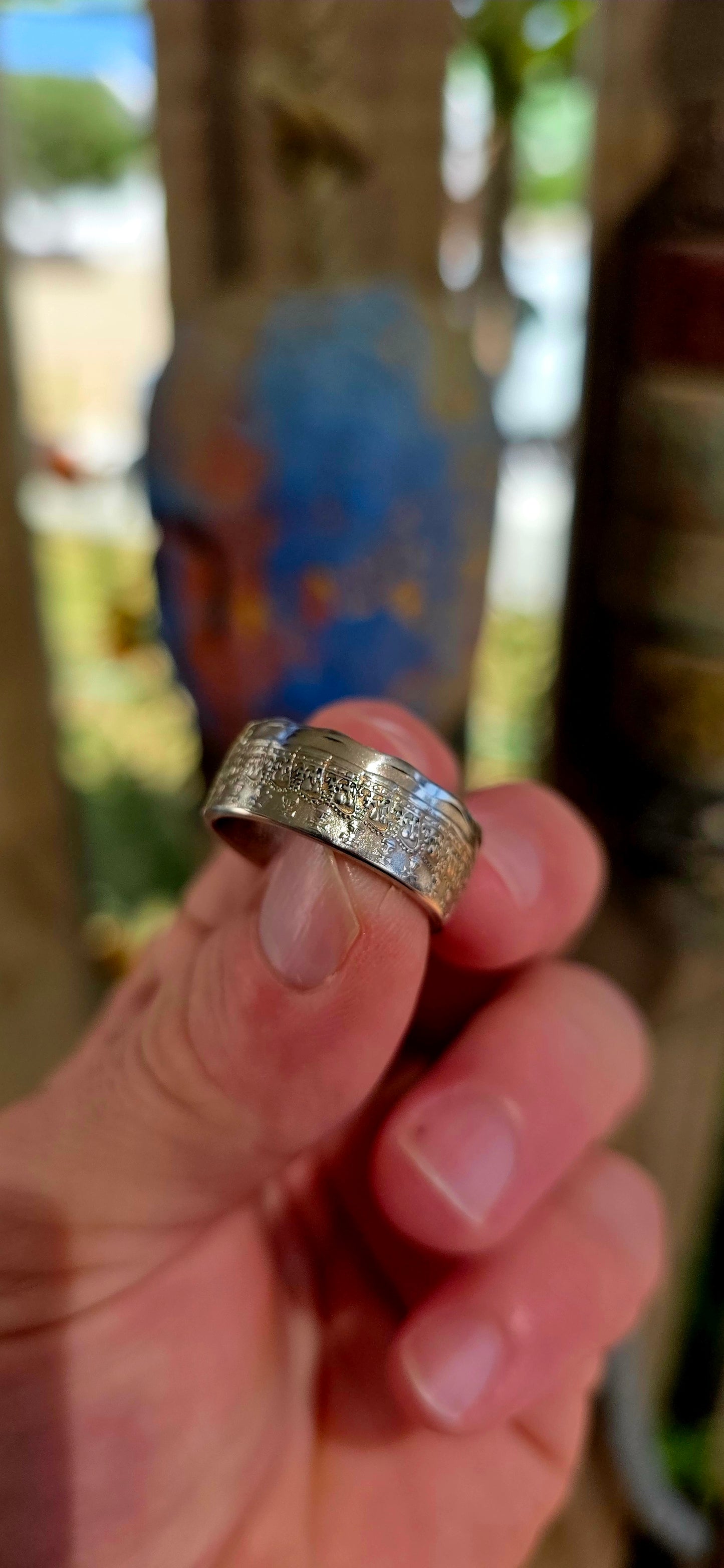 A bold, artisan-crafted coin ring, expertly formed from an authentic 1977 Australian 50 cent coin, struck in nickel and featuring Queen Elizabeth II.