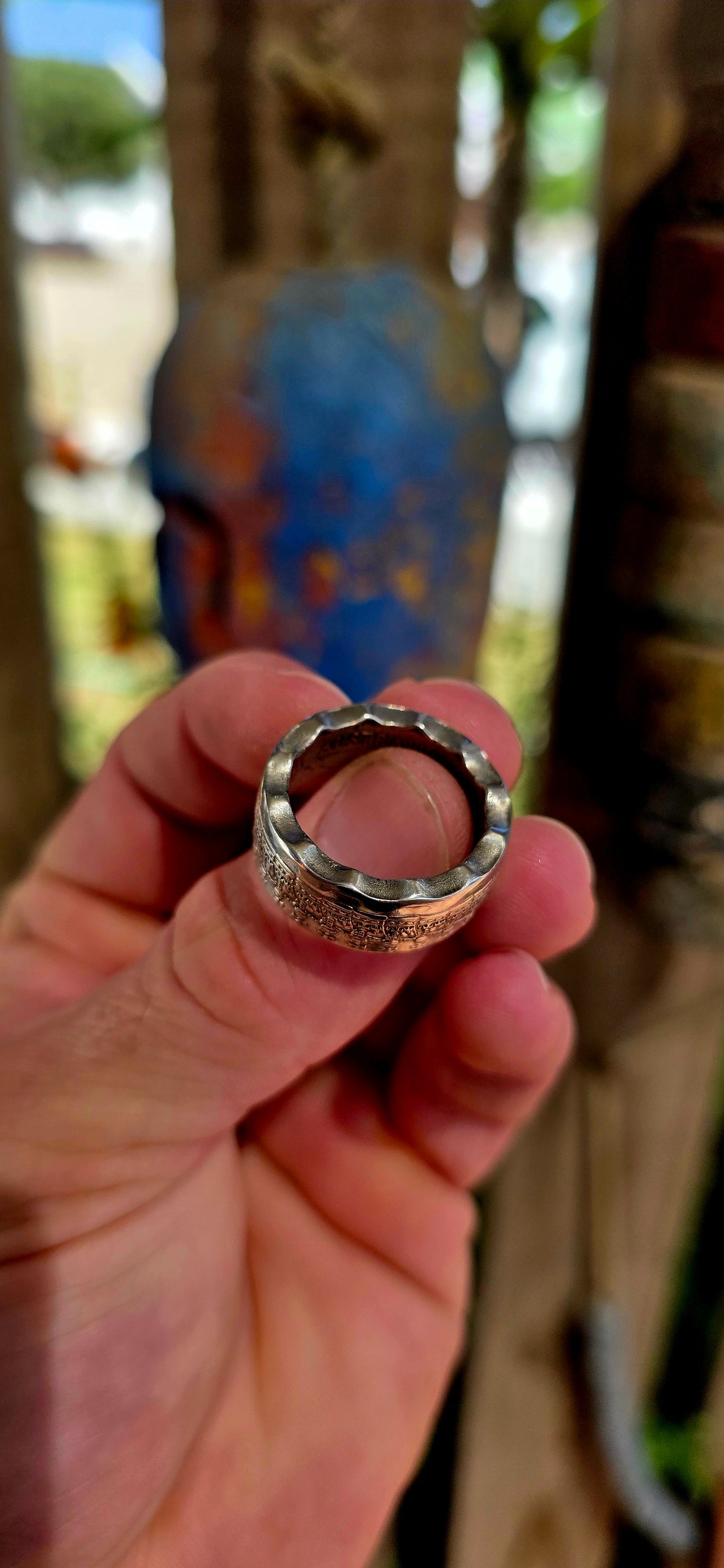 A bold, artisan-crafted coin ring, expertly formed from an authentic 1977 Australian 50 cent coin, struck in nickel and featuring Queen Elizabeth II.